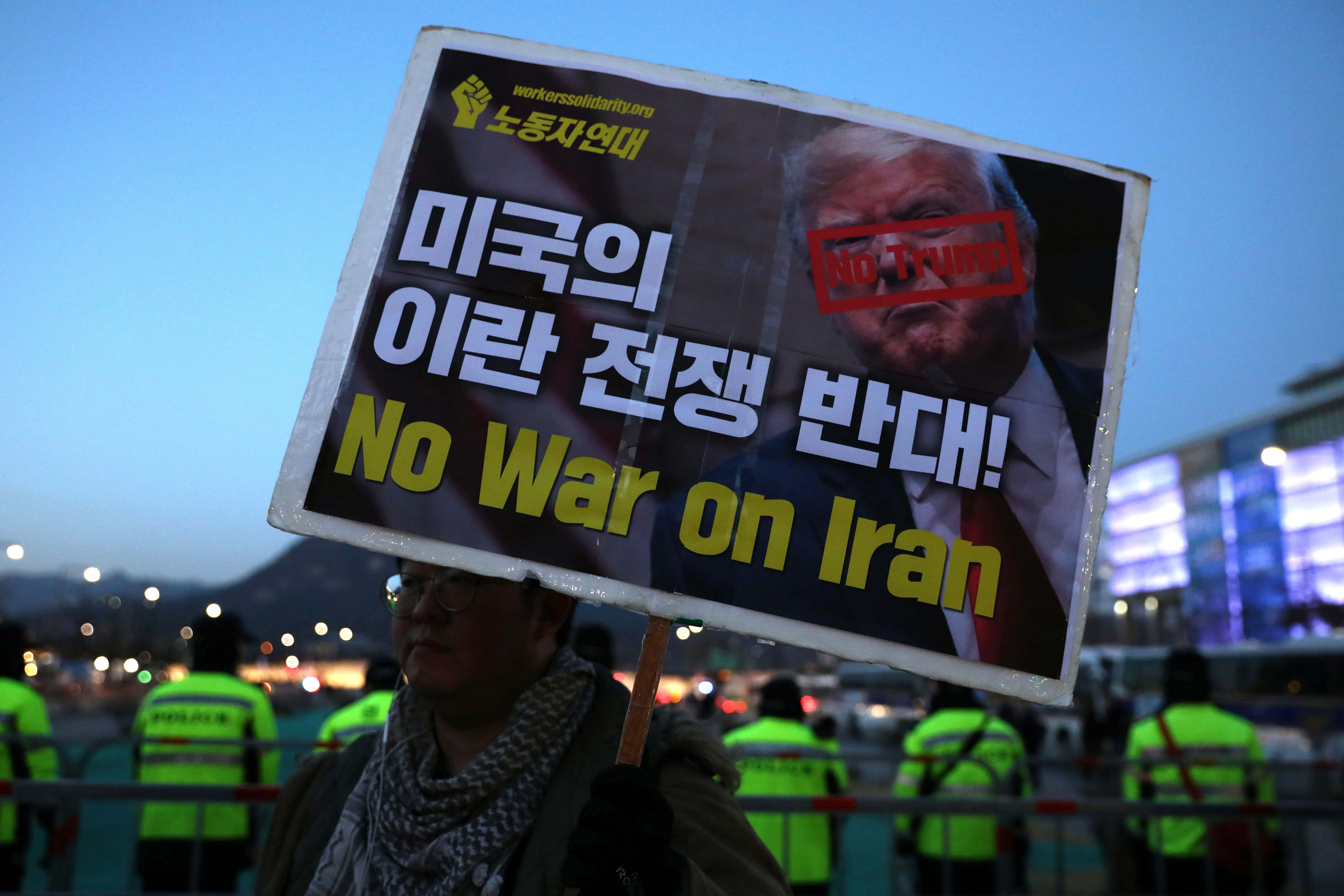 SEOUL, SOUTH KOREA - JANUARY 18: South Korean protesters holding signs take part in a protest agains