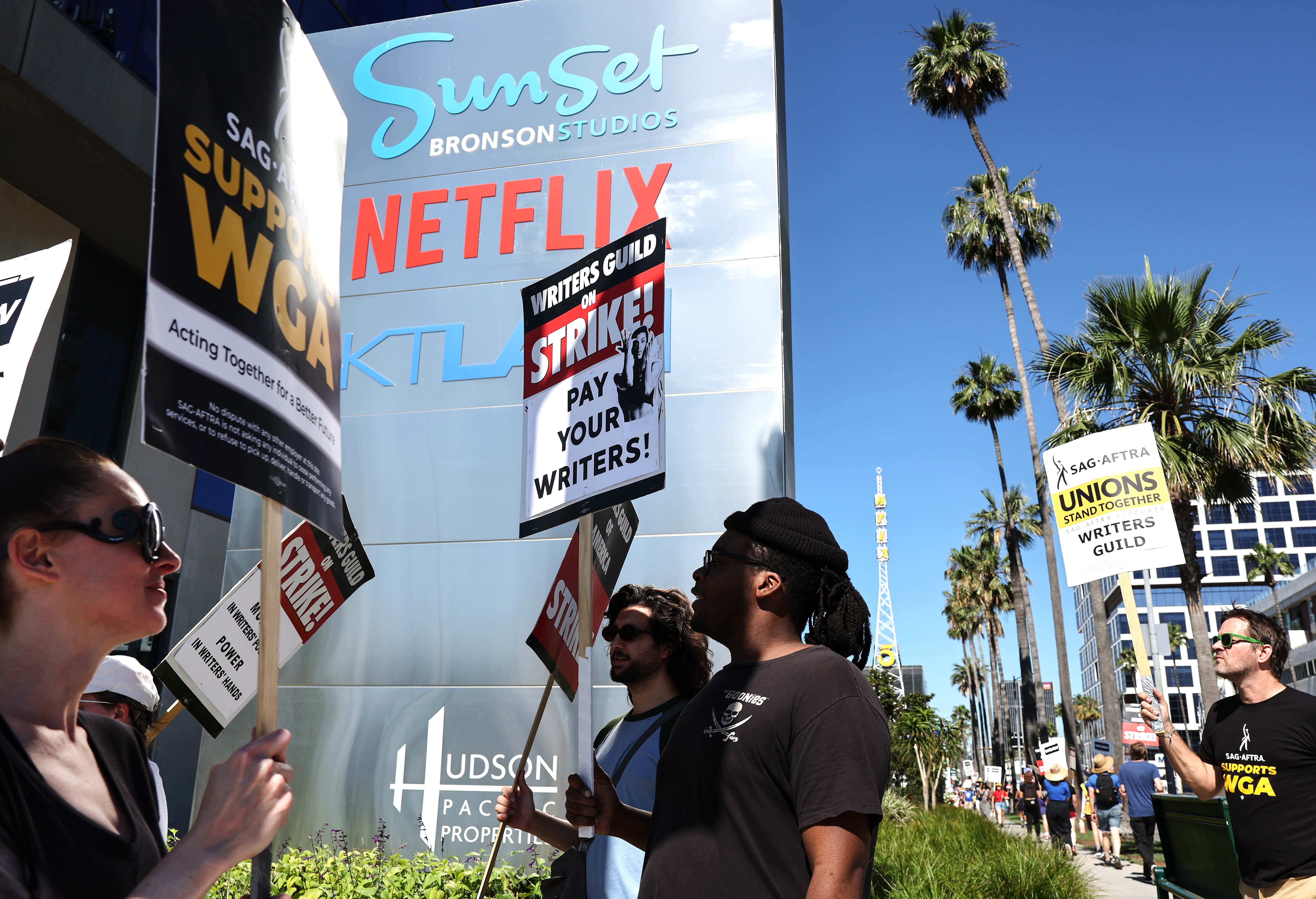 LOS ANGELES, CALIFORNIA - JULY 13: SAG-AFTRA members walk the picket line in solidarity with striking WGA (Writers Guild of America) workers outside Netflix offices on July 13, 2023 in Los Angeles, California. Members of SAG-AFTRA, Hollywood’s largest union which represents actors and other media professionals, will likely go on strike after a midnight deadline over contract negotiations with studios expired. The strike could shut down Hollywood productions completely with writers in the third month of their strike against Hollywood studios. (Photo by Mario Tama/Getty Images)
