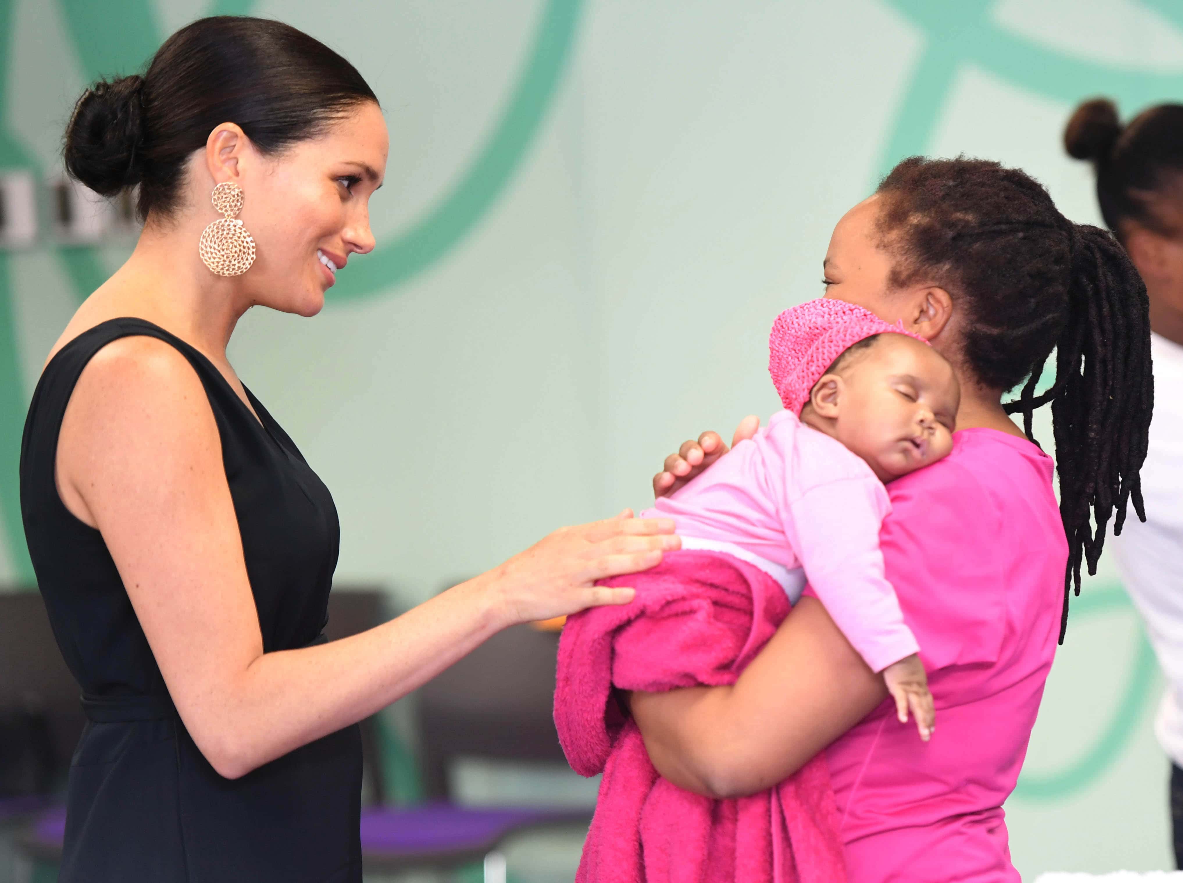 Meghan, Duchess of Sussex meets with with 7 weeks old Sumeya as she visits mothers2mothers during her royal tour of South Africa with Prince Harry, Duke of Sussex on September 25, 2019 in Cape Town, South Africa. mothers2mothers (m2m) is an African not-for-profit organisation with the vision of a healthy, HIV-free Africa. The organisation trains and employs women living with HIV as frontline health workers across eight African nations. (Photo by Paul Edwards - Pool/Getty Images)
