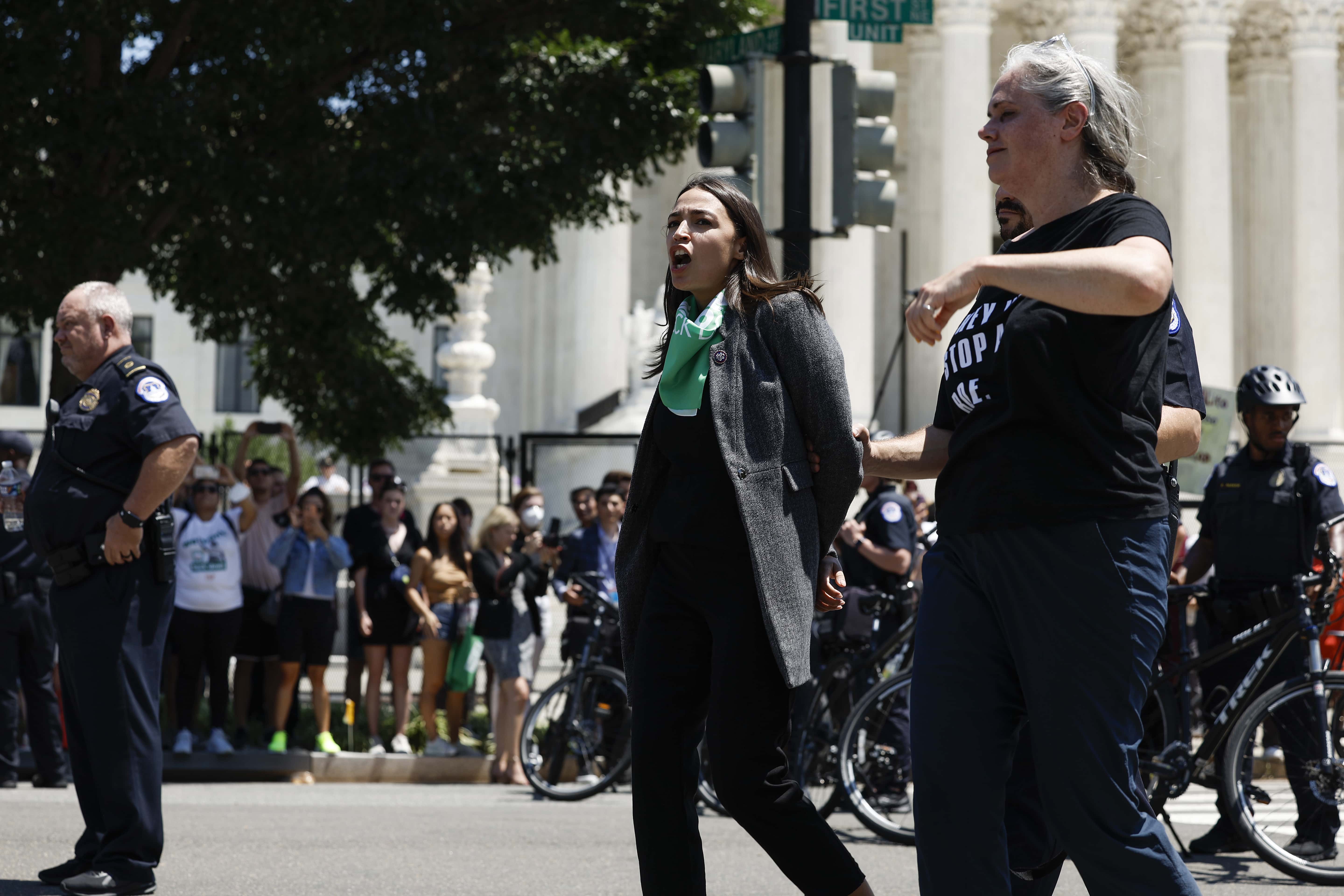Rep. Alexandria Ocasio-Cortez (D-NY) is detained by U.S. Capitol Police Officers after participating in a sit in with activists from Center for Popular Democracy Action (CPDA) in front of the U.S. Supreme Court Building on July 19, 2022 in Washington, DC. The CPDA held the protest with House Democrats in support of abortion rights. (Photo by Anna Moneymaker/Getty Images)