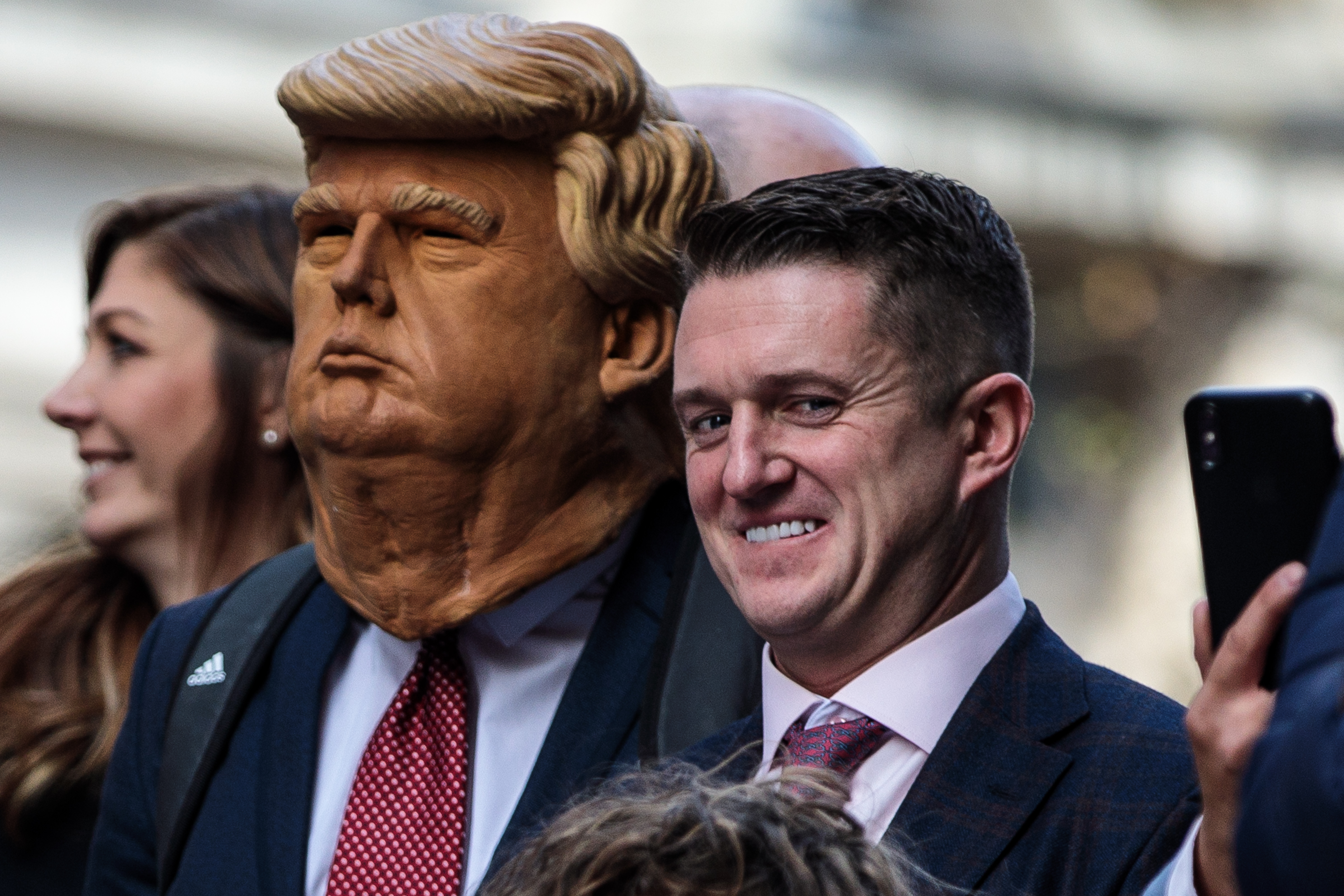 Far-right figurehead Tommy Robinson, real name Stephen Yaxley-Lennon stands beside a man in a Donald Trump mask as he addresses supporters outside the Old Bailey on October 23, 2018, in London, England. The Former English Defence League leader and British National Party member is facing a re-trial on charges of contempt. (Getty Images)