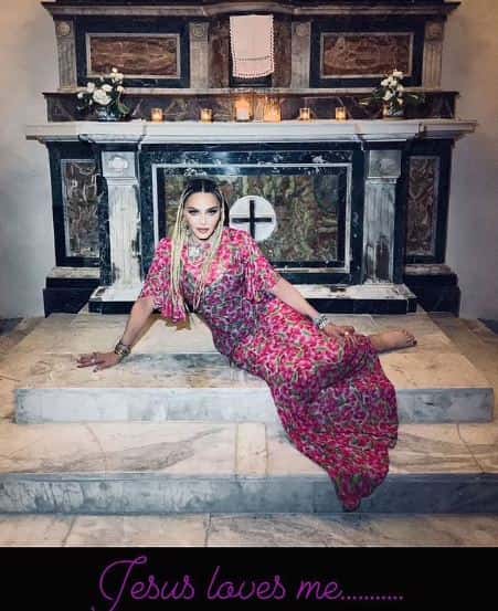 The pop star was sitting on the altar while posing for a snap with her pink floral dress (@Madonna/Instagram)