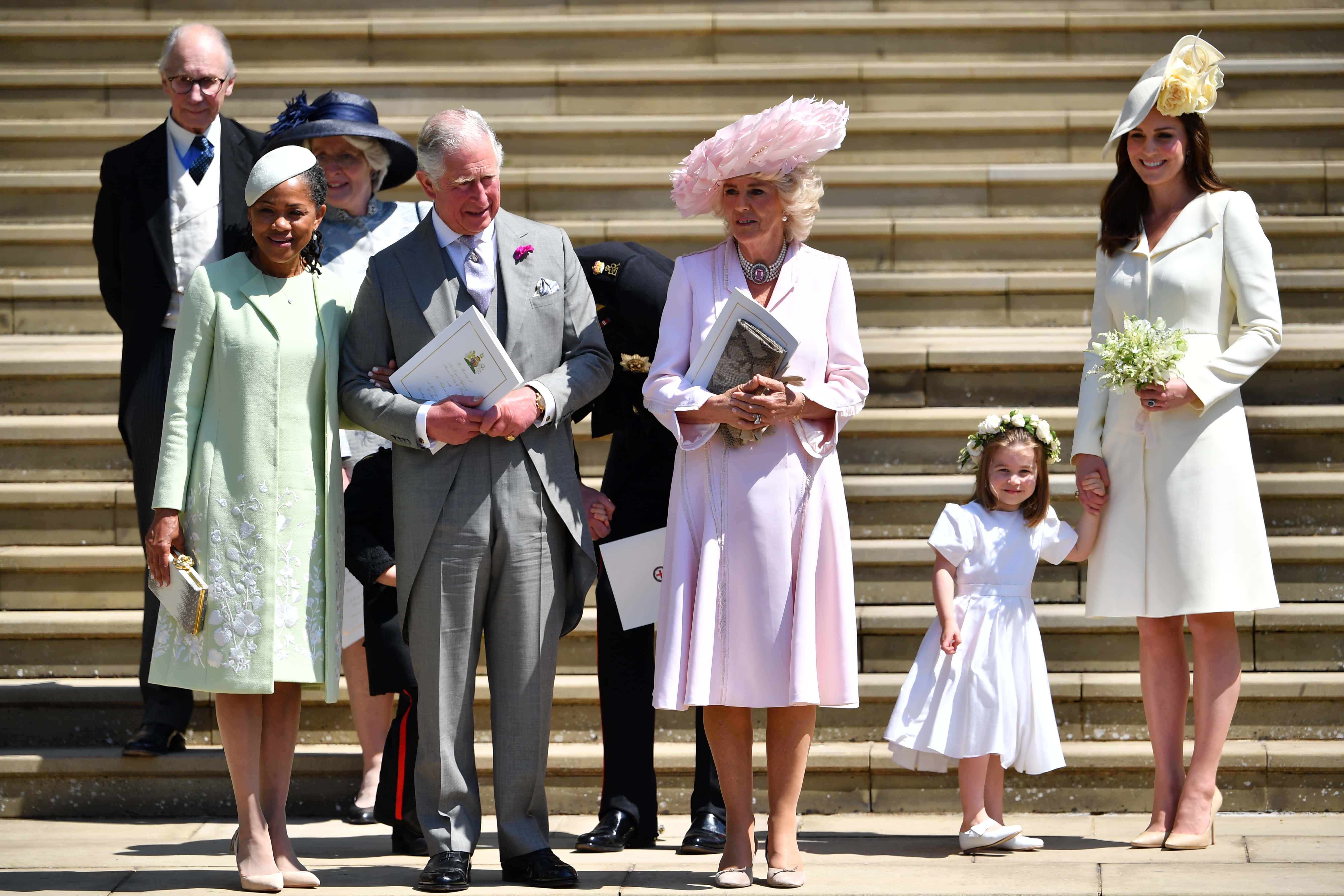 (L-R) Doria Ragland, Prince Charles, Prince of Wales, Camilla, Duchess of Cornwall, and Catherine, Duchess of Cambridge holding her daughter Princess Charlotte's hand as they leave from the West Door of St George's Chapel, Windsor Castle, in Windsor on May 19, 2018 in Windsor, England. (Photo by Ben STANSALL - WPA Pool/Getty Images)