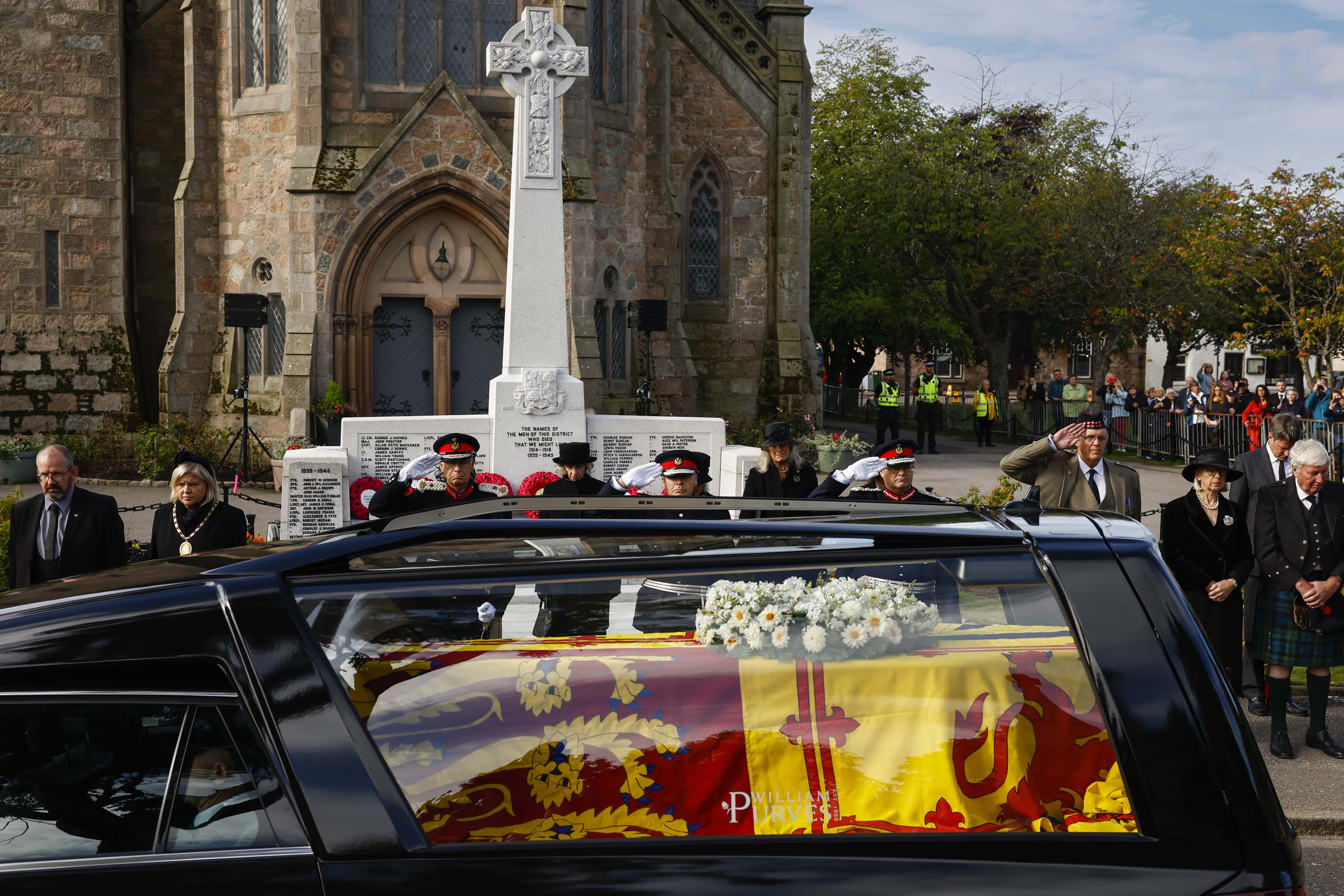 People gather in tribute as the cortege carrying the coffin of the late Queen Elizabeth II passes by on September 11, 2022 in Ballater, United Kingdom. Elizabeth Alexandra Mary Windsor was born in Bruton Street, Mayfair, London on 21 April 1926. She married Prince Philip in 1947 and ascended the throne of the United Kingdom and Commonwealth on 6 February 1952 after the death of her Father, King George VI. Queen Elizabeth II died at Balmoral Castle in Scotland on September 8, 2022, and is succeeded by her eldest son, King Charles III.