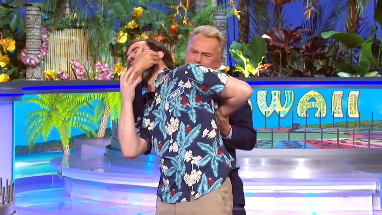'Wheel of Fortune' host Pat Sajak playing around with contestant Fred Jackson by putting him in a chokehold (Screenshot, @WheelofFortune/YouTube)