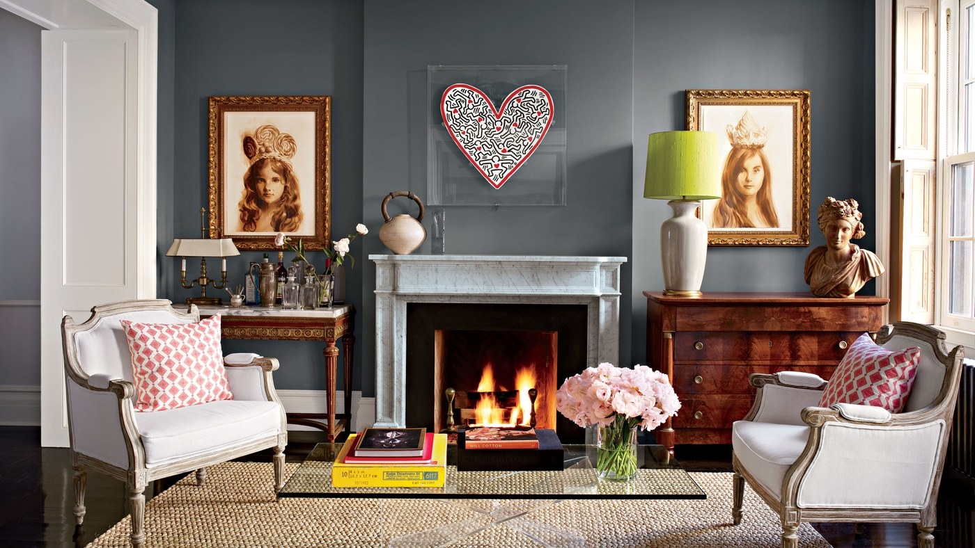 The living room features Louis XVI–style armchairs, a French Empire commode, and a 1970s Lucite-base cocktail table. A Keith Haring painting (a gift from the artist) and portraits by Will Cotton of Shields’s two daughters hang on walls painted in Benjamin Moore’s Chelsea Gray.
