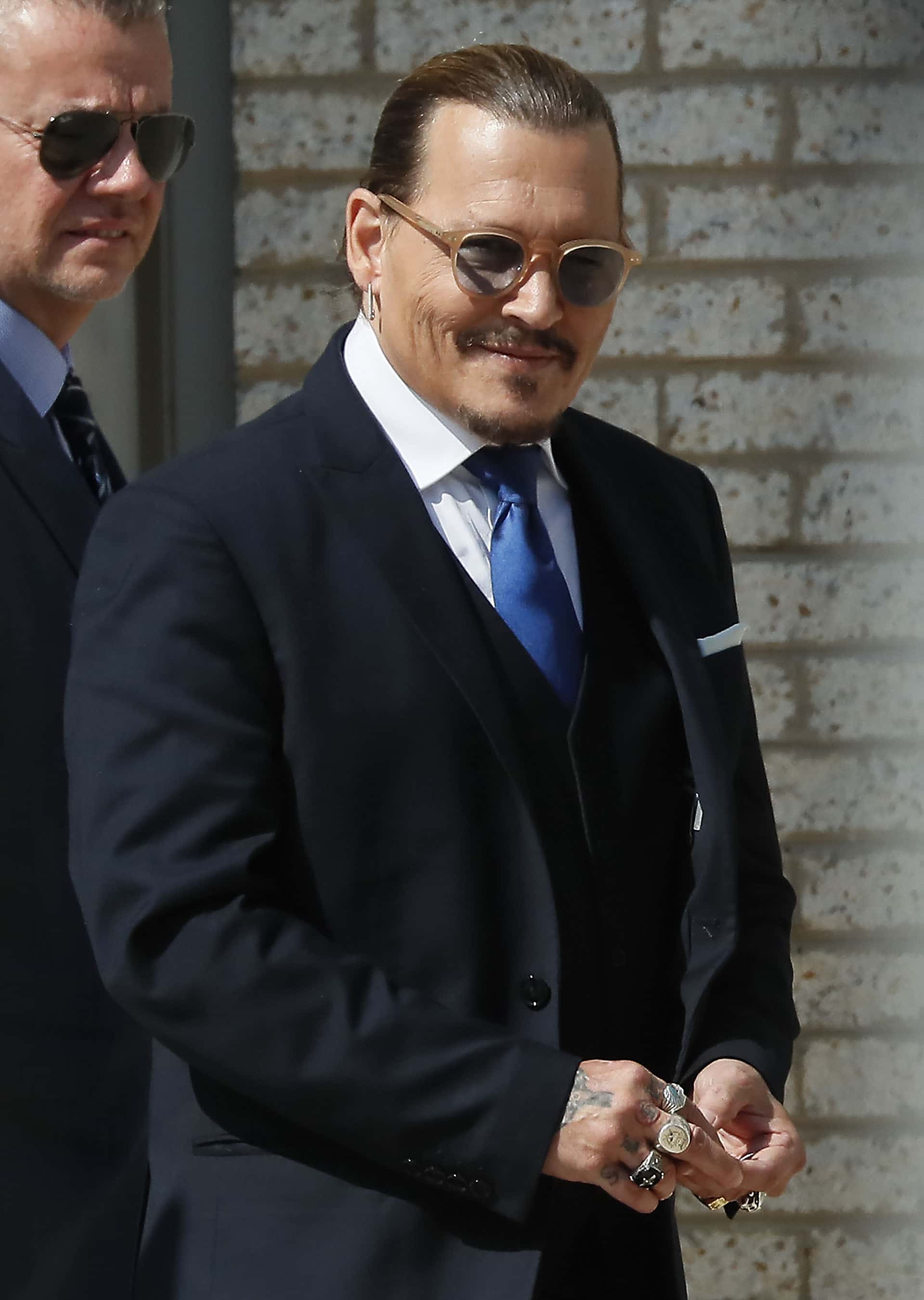 Johnny Depp steps outside court during his civil trial at Fairfax County Circuit Court on April 25, 2022 in Fairfax, Virginia. Depp is seeking $50 million in alleged damages to his career over an op-ed Heard wrote in the Washington Post in 2018.