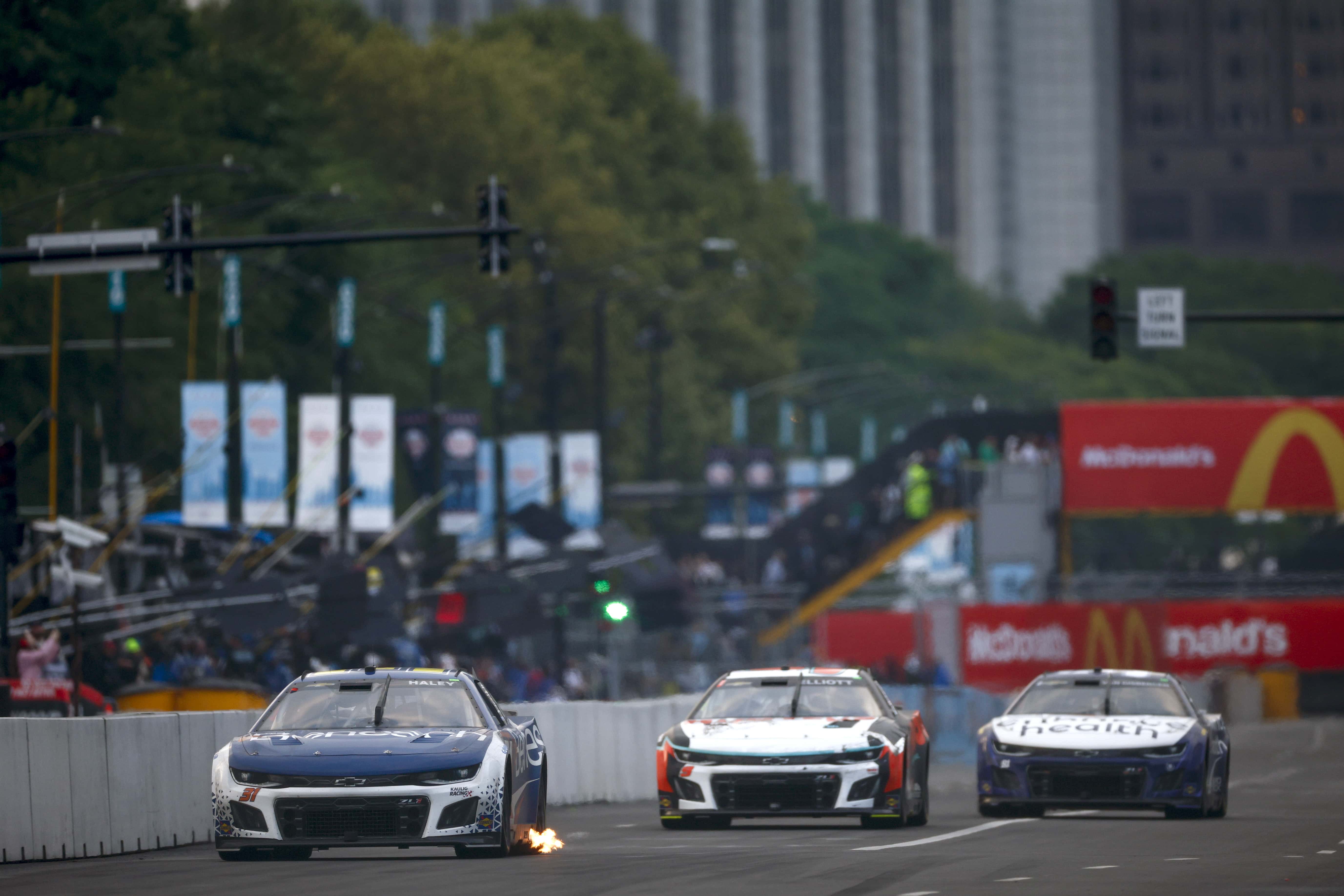 CHICAGO, ILLINOIS - JULY 02: Justin Haley, driver of the #31 Benesch Law Chevrolet, Chase Elliott, driver of the #9 Hooters Chevrolet, and Shane Van Gisbergen, driver of the #91 Enhance Health Chevrolet, race during the NASCAR Cup Series Grant Park 220 at the Chicago Street Course on July 02, 2023 in Chicago, Illinois. (Photo by Jared C. Tilton/Getty Images)