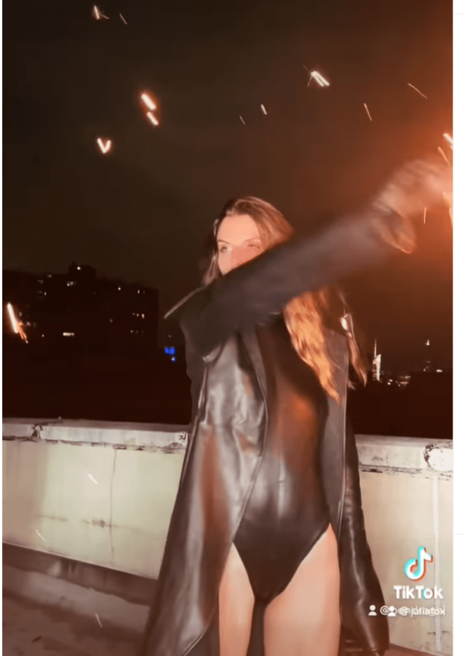 Fox styled a structured leotard and knee-high stiletto boots underneath the pyro-piece. (Instagram/@juliafox)