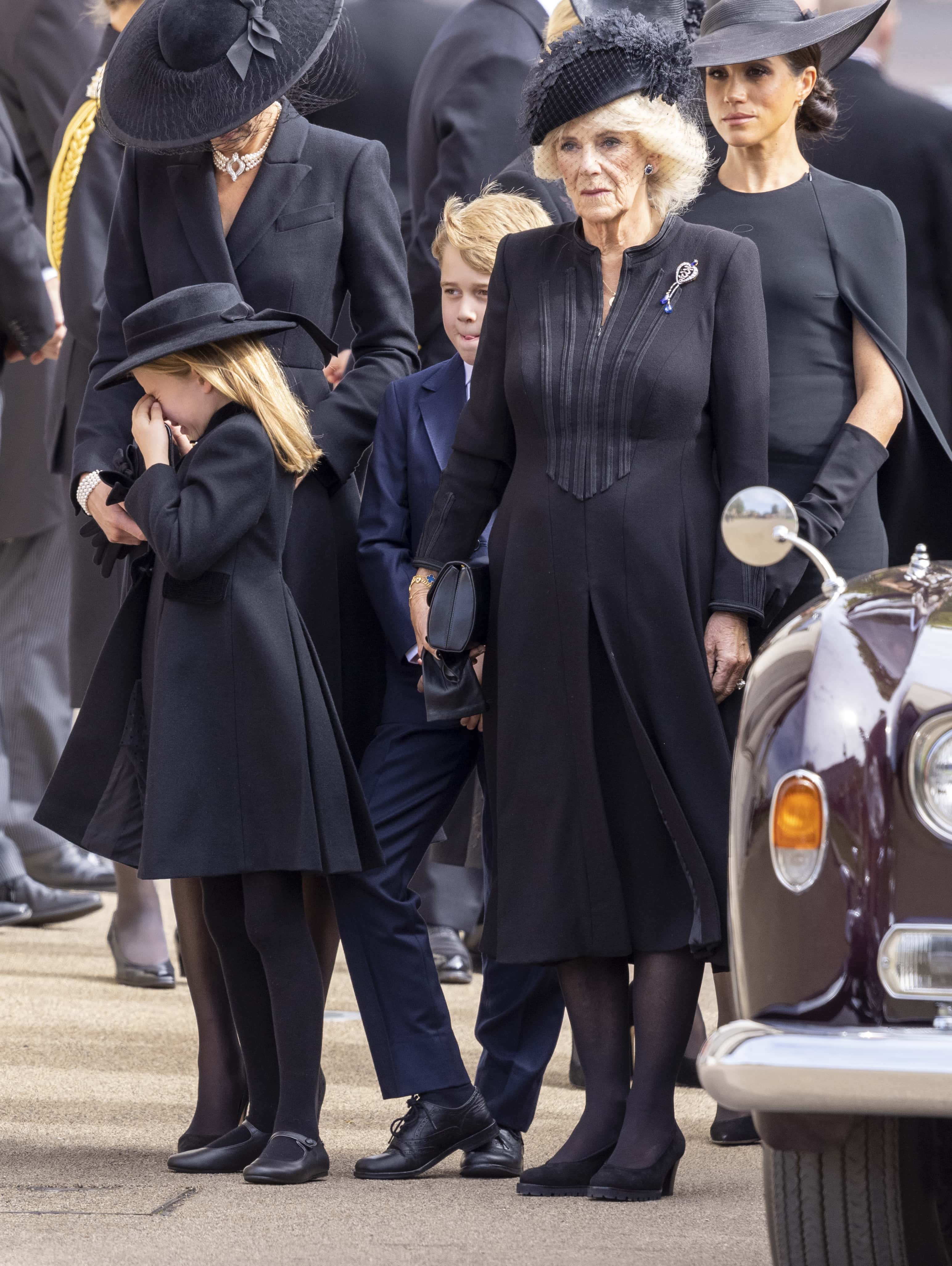 Princess Charlotte of Wales cries next to Catherine, Princess of Wales, Prince George of Wales and Camilla, Queen Consort  next Prince George of Wales and Camilla, Queen Consort after watching the Coffin of Queen Elizabeth II being transferred to the hearse at Wellington Arch following the State Funeral of Queen Elizabeth II on September 19, 2022 in London, England.  Elizabeth Alexandra Mary Windsor was born in Bruton Street, Mayfair, London on 21 April 1926. She married Prince Philip in 1947 and ascended the throne of the United Kingdom and Commonwealth on 6 February 1952 after the death of her Father, King George VI. Queen Elizabeth II died at Balmoral Castle in Scotland on September 8, 2022, and is succeeded by her eldest son, King Charles III.