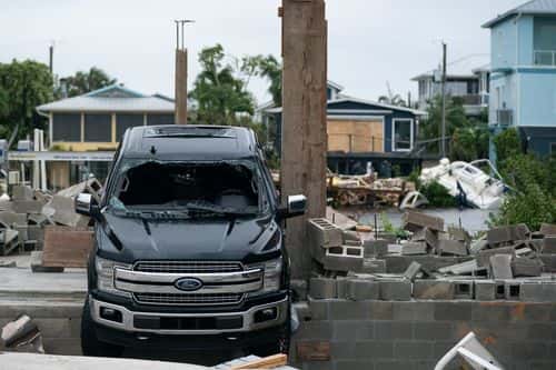 A storm damaged truck after Hurricane Ian on September 29, 2022 in Bonita Springs, Florida. Hurricane Ian brought high winds, storm surge and rain to the area causing severe damage.