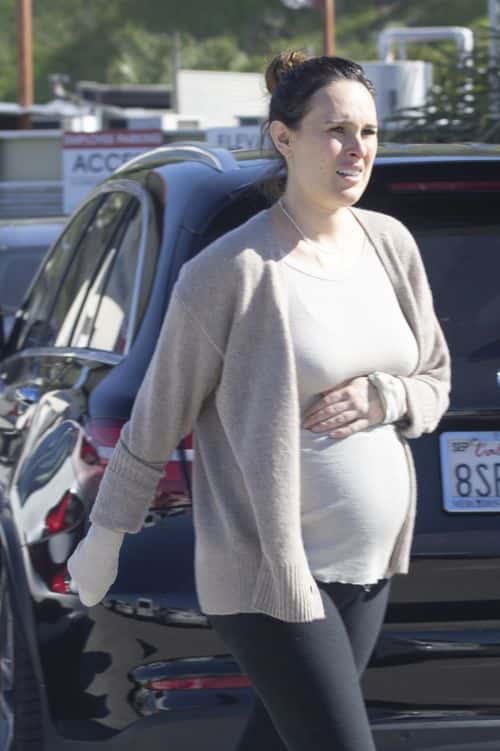 Rumer Willis cradles baby bump while leaving doctor's office. (Backgrid)