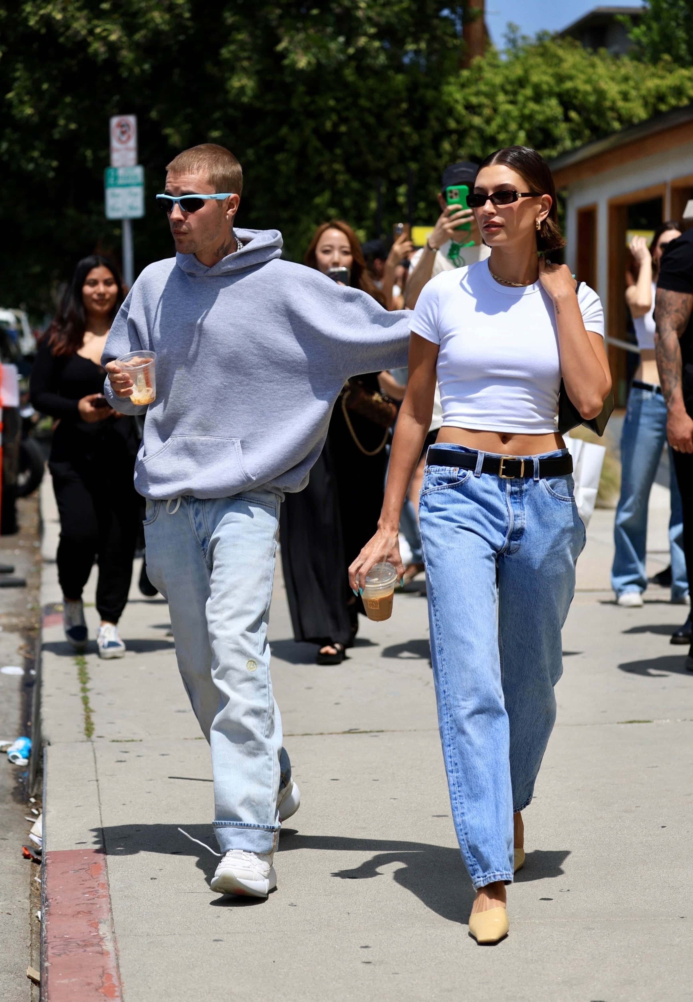 Hailey Bieber and Justin Bieber made a cute pair as they dropped by a cafe in Los Angeles for a Rhode pop-up event (Backgrid)