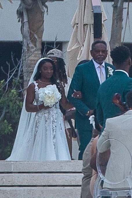 Simone's father, Ronald Biles, led her down the aisle, while her uncle, Paul, presided over the wedding (Backgrid)