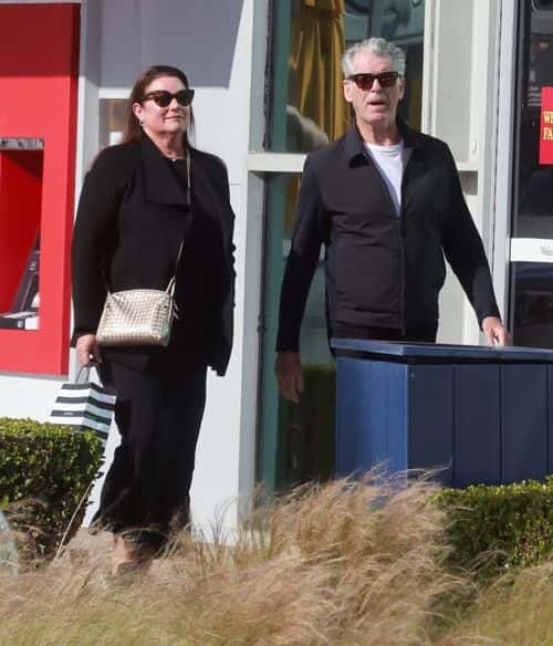 His wife Keely, 59, sported a stylish grey jumper, midi skirt and wooly black jacket for their day (Backgrid)