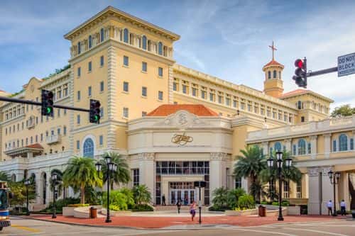 People walk in front of the Flag Building, the Church of Scientology's headquarters, in downtown Clearwater Florida USA on a sunny day.