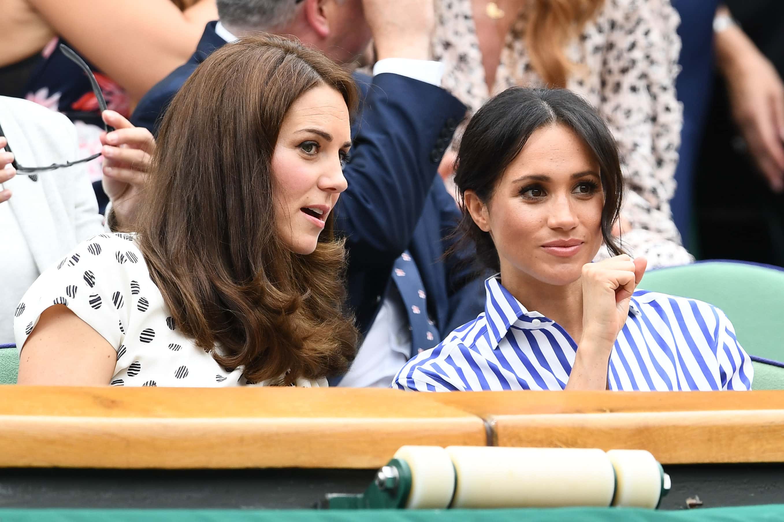 Catherine, Duchess of Cambridge and Meghan, Duchess of Sussex attend day twelve of the Wimbledon Lawn Tennis Championships at All England Lawn Tennis and Croquet Club on July 14, 2018 in London, England. (Photo by Clive Mason/Getty Images)