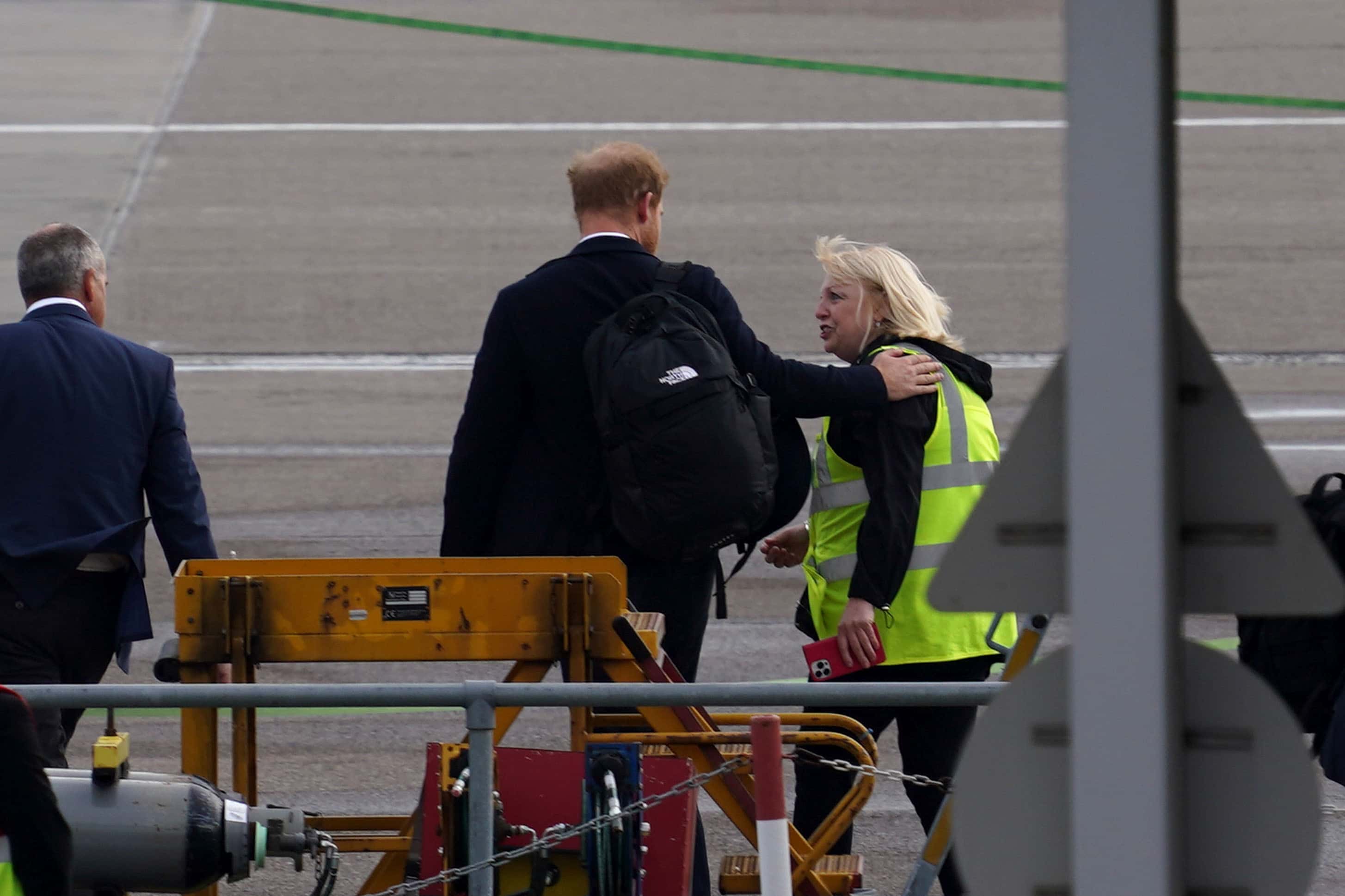 Prince Harry comforting Airport Staff (getty Images)