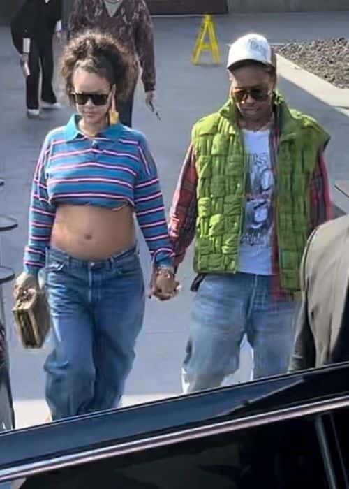 Rihanna wore denim blue jeans to match her low-cut stripy top. (Backgrid)