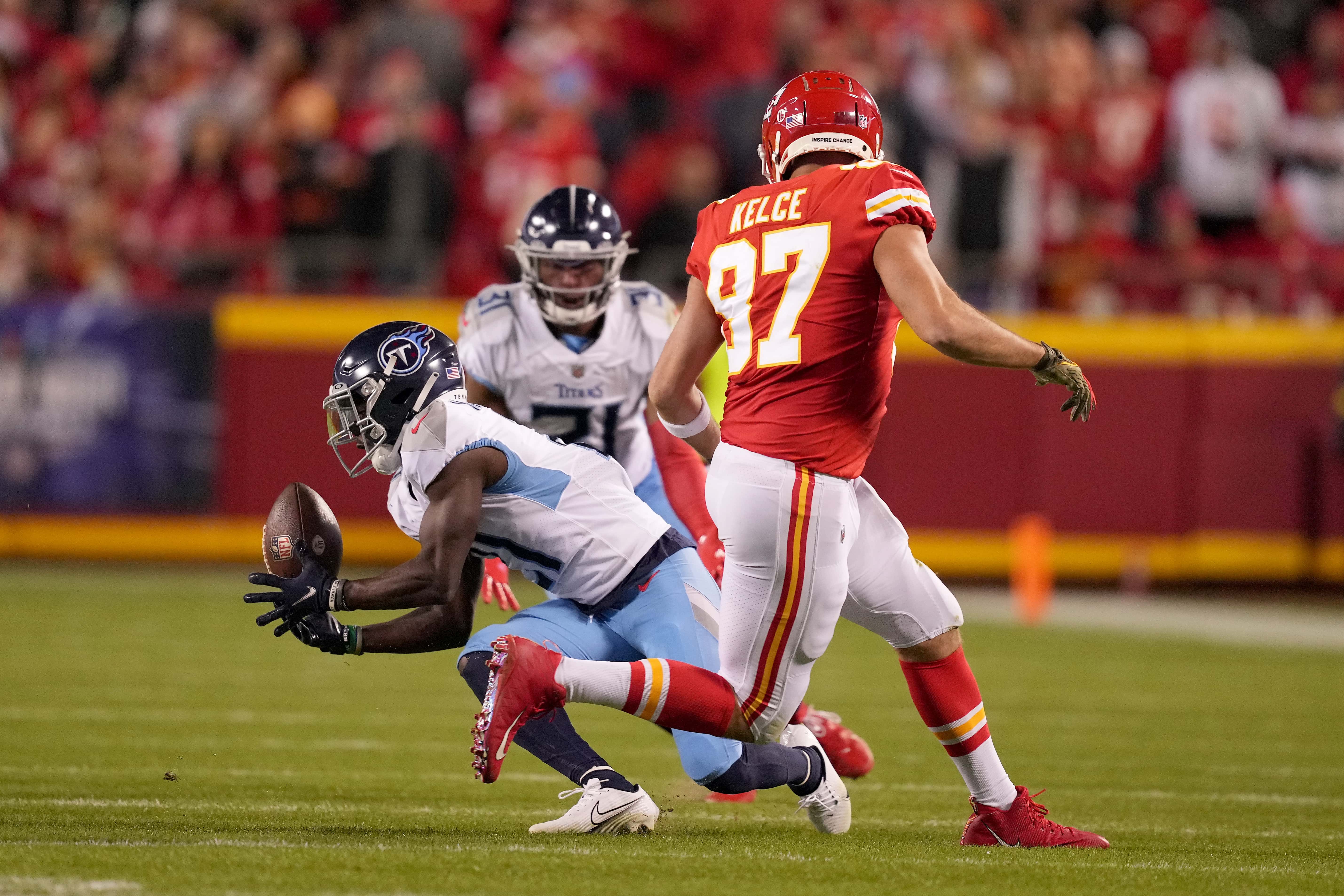 Roger McCreary #21 of the Tennessee Titans intercepts a pass intended for Travis Kelce #87 of the Kansas City Chiefs in the second half at Arrowhead Stadium on November 06, 2022 in Kansas City, Missouri.