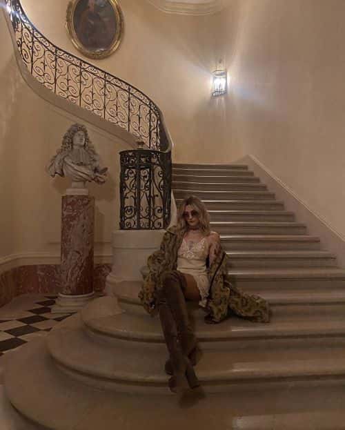 Paris wearing brown knee-high platform boots and a multi-colored floral jacket, hanging over her shoulders (@parisjackson/Instagram)