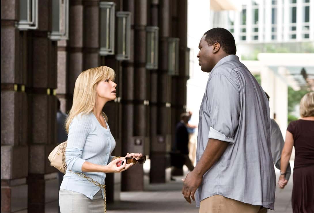 Quinton Aaron towers over Sandra Bullock in the movie 'The Blind Side' (IMDb)