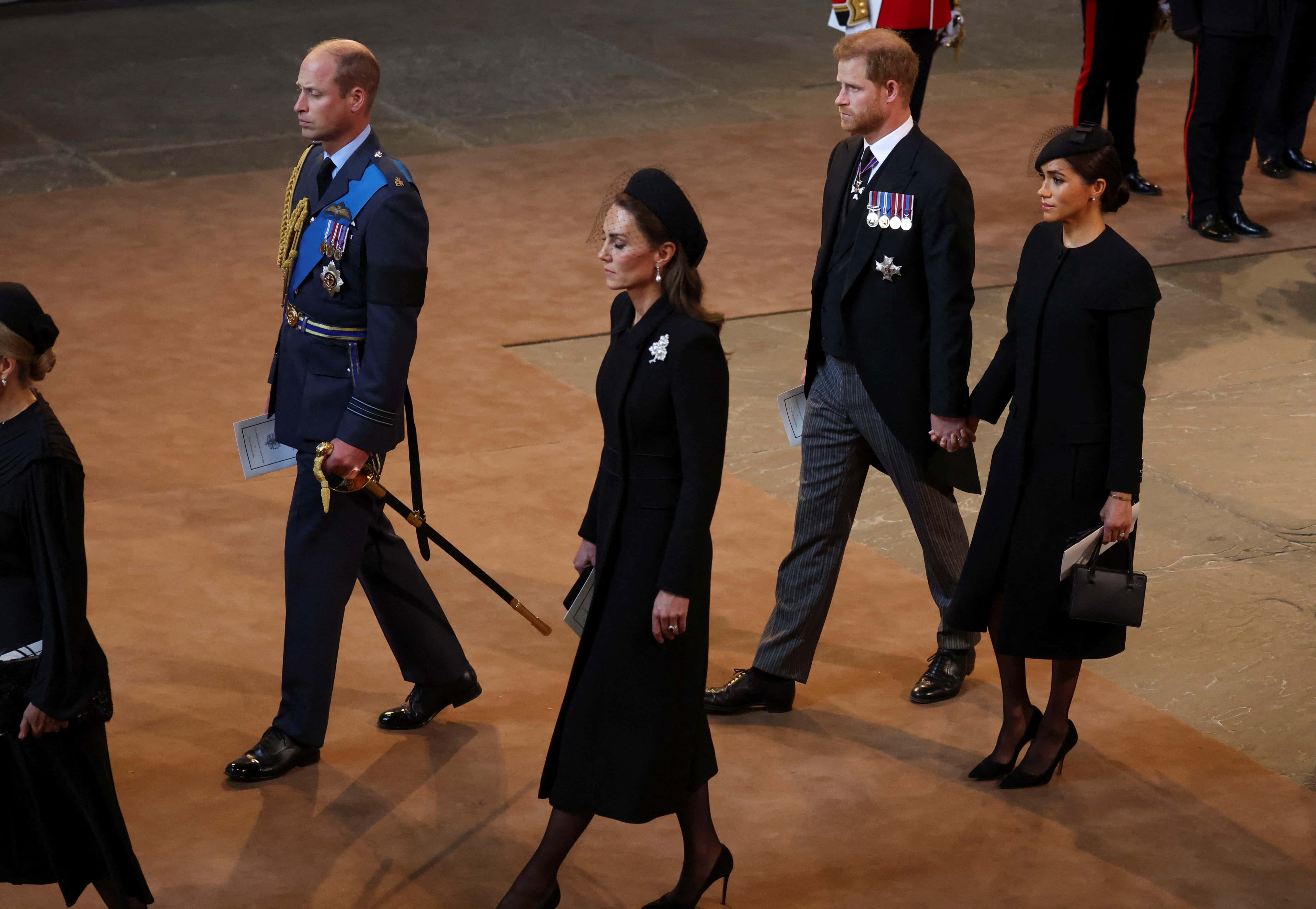 Prince William, Prince of Wales, Catherine, Princess of Wales, Prince Harry, Duke of Sussex and Meghan, Duchess of Sussex walk as procession with the coffin of Britain's Queen Elizabeth arrives at Westminster Hall from Buckingham Palace for her lying in state, on September 14, 2022 in London, United Kingdom. Queen Elizabeth II's coffin is taken in procession on a Gun Carriage of The King's Troop Royal Horse Artillery from Buckingham Palace to Westminster Hall where she will lay in state until the early morning of her funeral. Queen Elizabeth II died at Balmoral Castle in Scotland on September 8, 2022, and is succeeded by her eldest son, King Charles III.