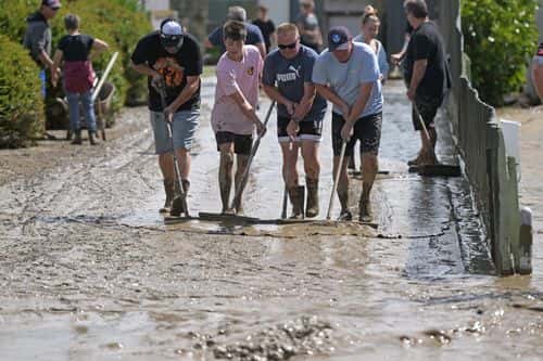 Residents in Taradale clean up silt following flood waters on February 15, 2023 in Napier, New Zealand. Cyclone Gabrielle has caused widespread destruction across New Zealand's North Island with thousands displaced and at least three reported deaths. (Photo by Kerry Marshall/Getty Images)
