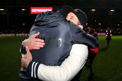 Ryan Reynolds and Rob McElhenney, Owners of Wrexham embrace after Wrexham win the Vanarama National League and are promoted to the English Football League after victory in the Vanarama National League match between Wrexham and Boreham Wood at Racecourse Ground on April 22, 2023 in Wrexham, Wales.
