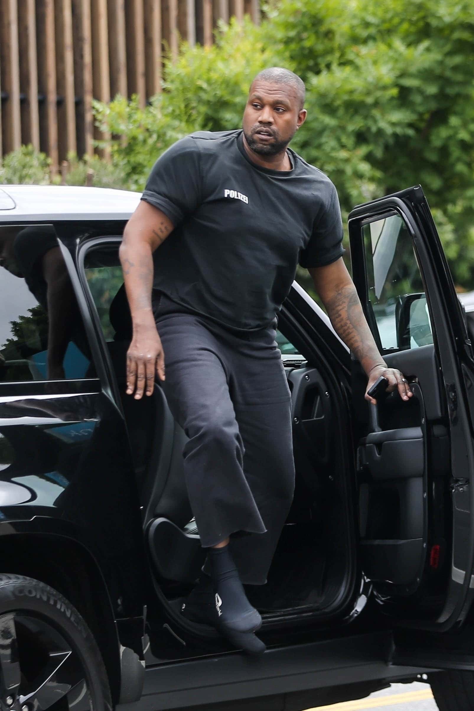 The whole family went for all-black looks, while the kids twinned in black tees and shorts (Backgrid)