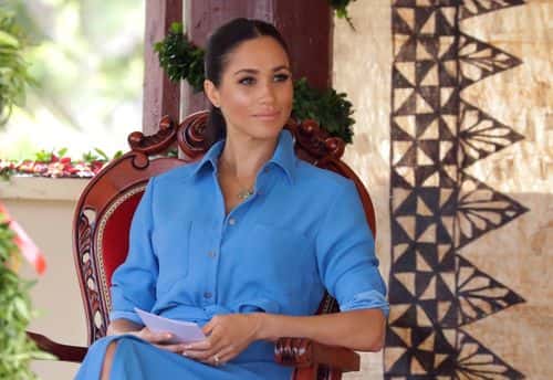 Meghan, Duchess of Sussex talks with students during a visit to Tupou College in Tonga on October 26, 2018. Prince Harry and his wife Meghan are on day 11 of their 16-day tour of Australia and the South Pacific. (Photo by Kirsty Wigglesworth - Pool/Getty Images)