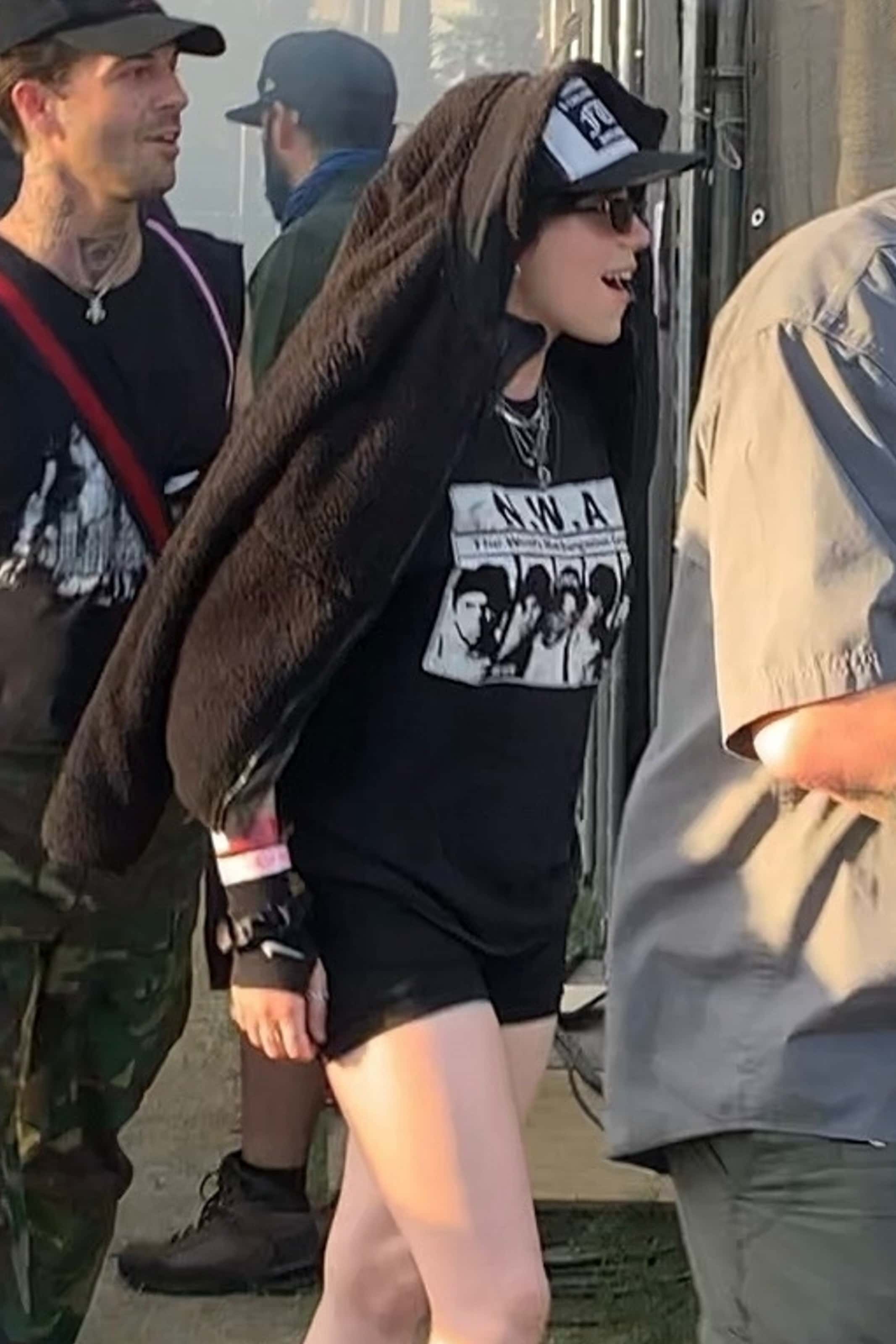 Dressed in black shorts, an NWA t-shirt, and combat boots, the pop star made her way around the festival grounds with a beaming smile (Backgrid)