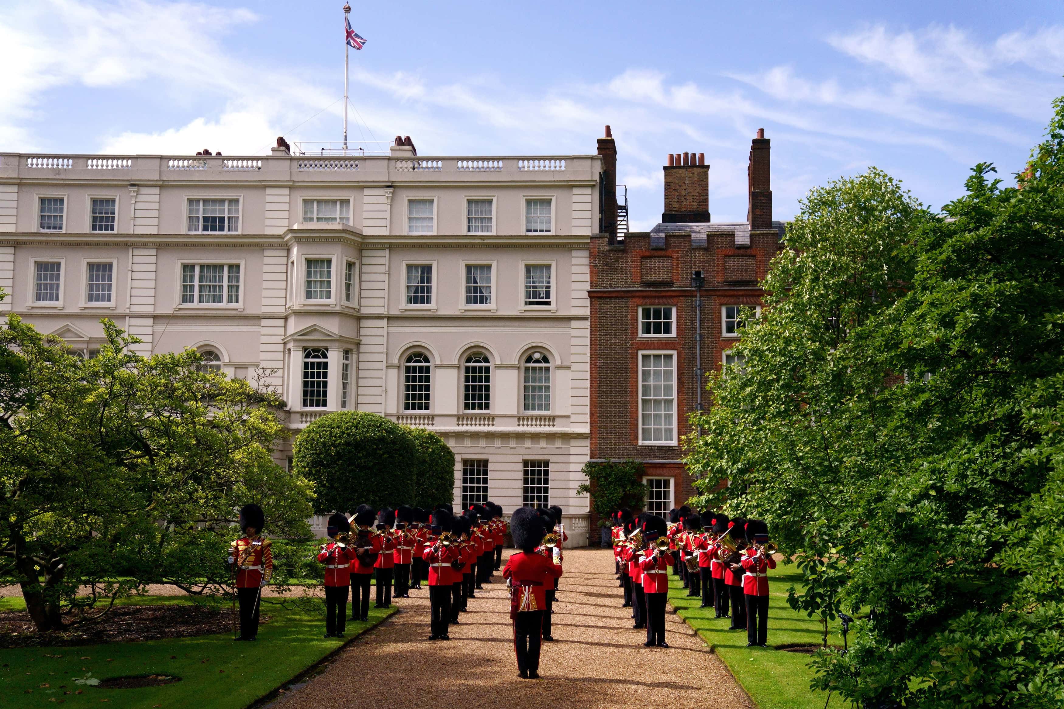 The Band of the Coldstream Guards play 'Three Lions' and 'Sweet Caroline' in the gardens of Clarence House ahead of England's Euro 2020 semi-final game against Denmark on July 6, 2021 in in London, England. In support to the England Football Team as they approach their Semi-Final match in the UEFA Euro Championships on Wednesday evening The Prince of Wales and The Duchess of Cornwall invited the Band of the Coldstream Guards into the Clarence House Garden to play the following pieces: Three Lions – Composed by Ian Broudie, arranged by Oliver Jeans and Sweet Caroline – Composed by Neil Diamond, arranged by Tim Waters.