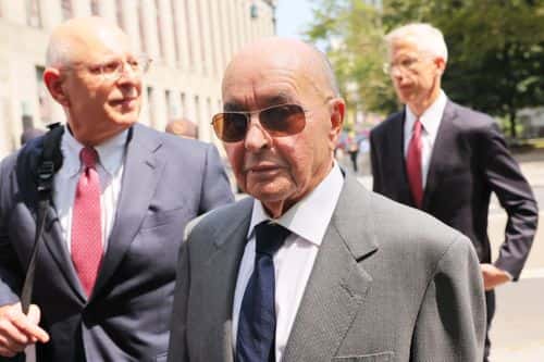 British billionaire owner of Tottenham Hotspur Joe Lewis is escorted by his attorneys after leaving Manhattan Federal Court on July 26, 2023 in New York City. Lewis turned himself in after being charged with orchestrating an insider trading scheme to enrich his friends, lovers and employees, including two private jet pilots.