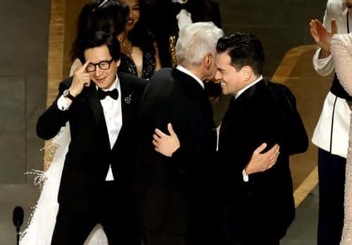 Ke Huy Quan (L) and Jonathan Wang (R) accept the Best Picture award for