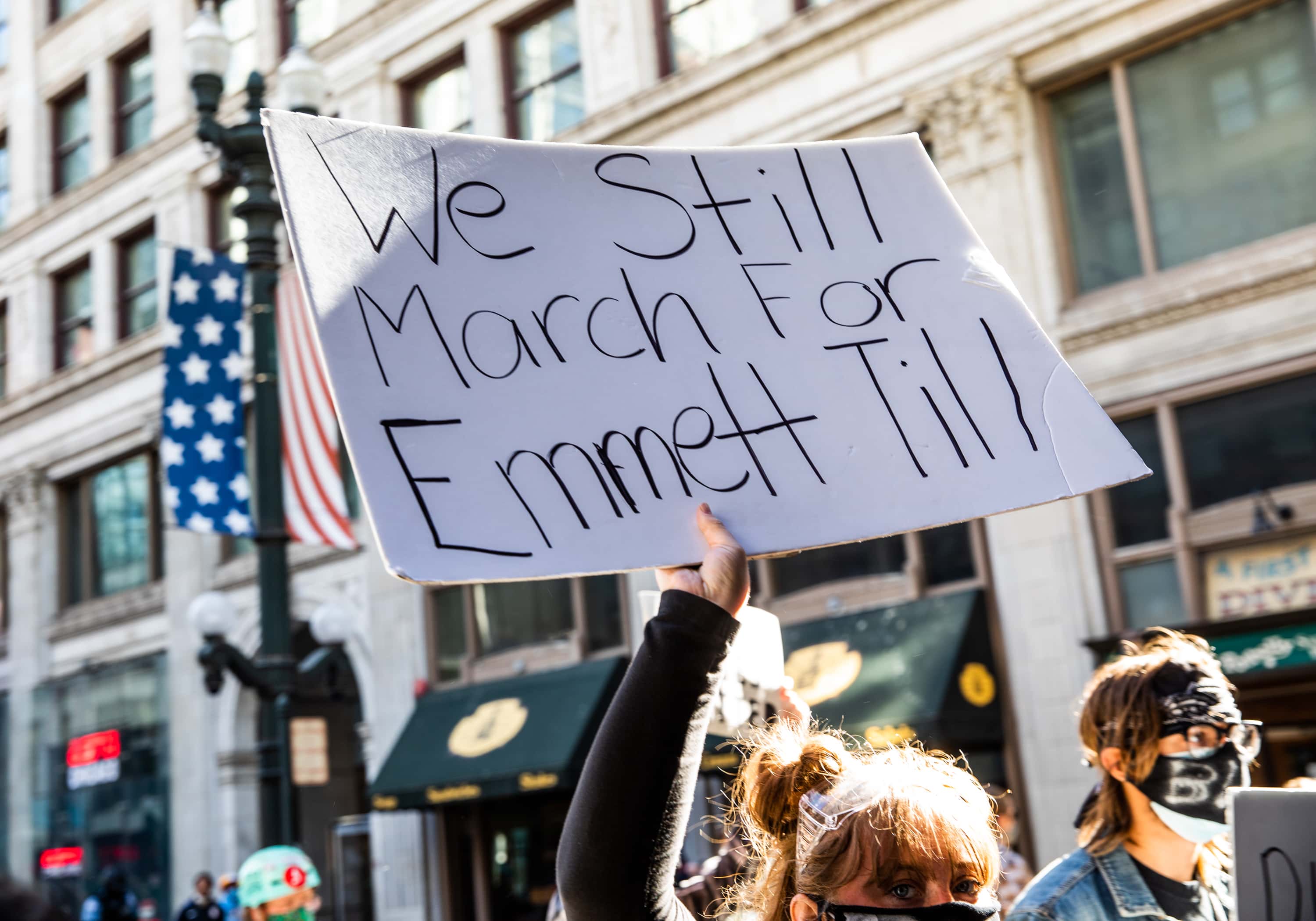 A woman holds a sign in honor of Emmett Till during a protest on June 13, 2020 in Chicago, Illinois. Protests erupted across the nation after George Floyd died in police custody in Minneapolis, Minnesota on May 25th.