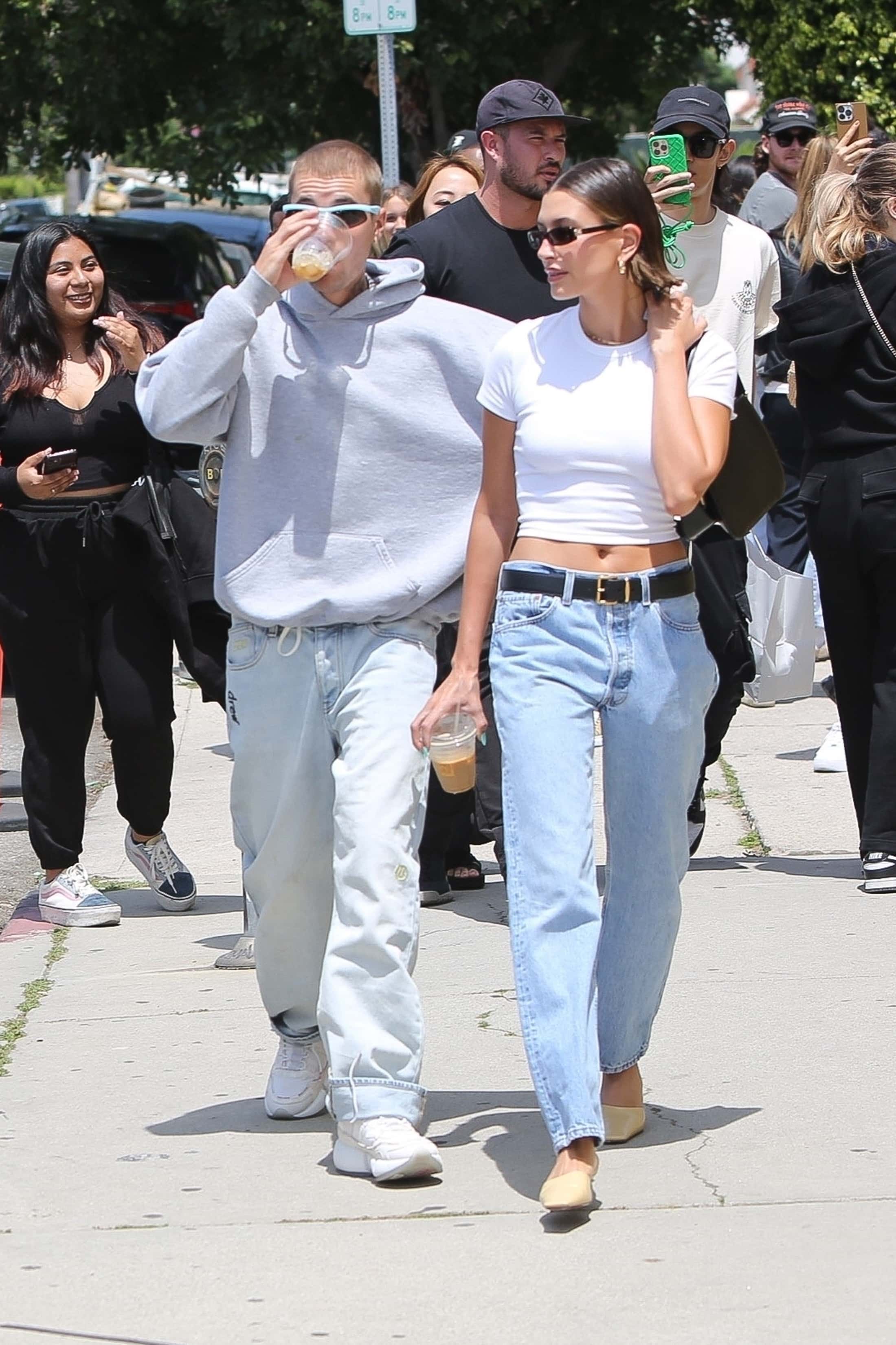 Justin matched his wife's laidback look as he sported a heather gray hoodie with sporty sunglasses with blue frames (Backgrid)