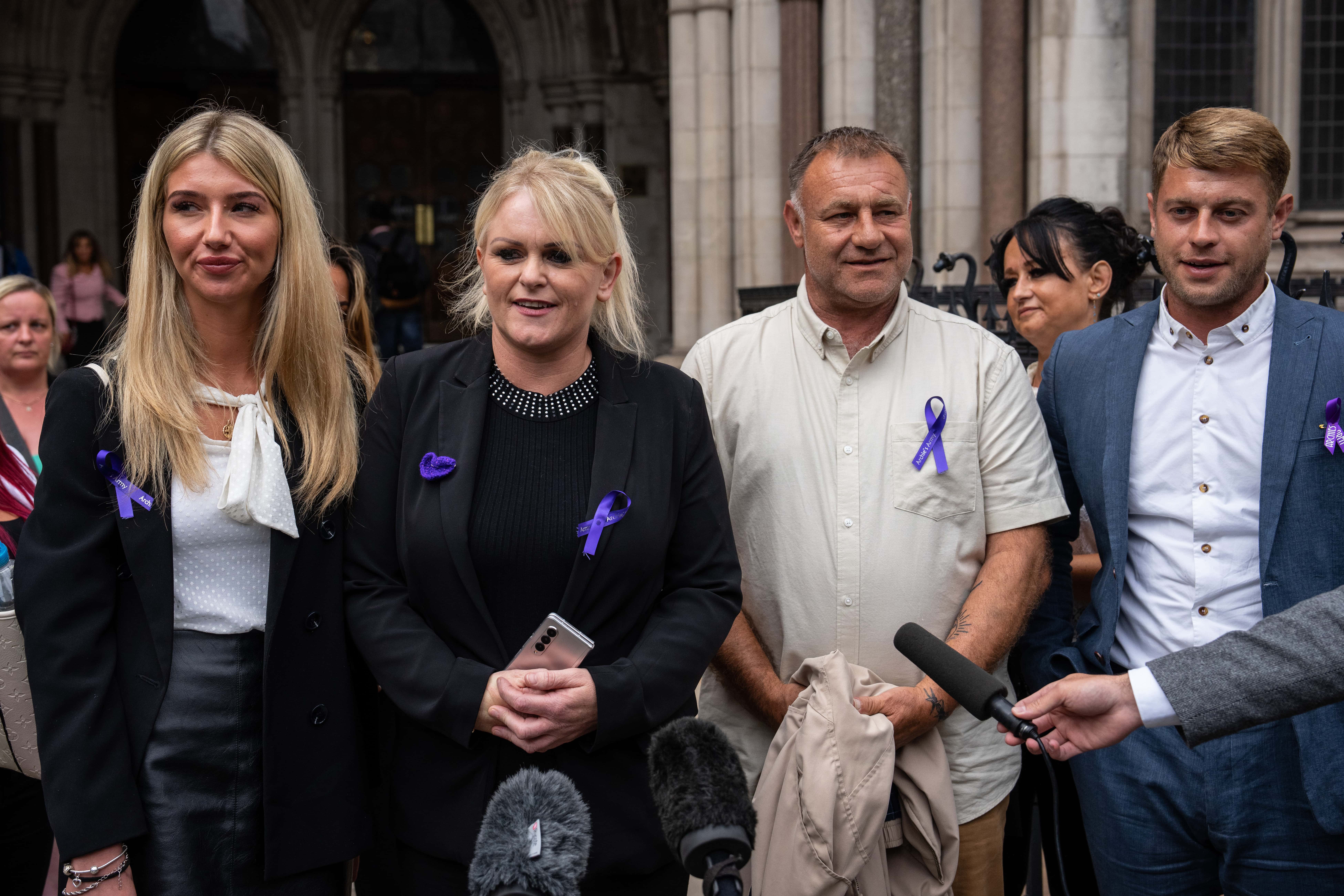 Hollie Dance (C-L) and Paul Battersbee (C-R), the mother and father of Archie Battersbee, speak to the media as they leave the Royal Courts of Justice after winning an appeal for his case to be heard again, on June 29, 2022 in London, England. The Court of Appeal has heard a plea by the family of 12-year-old Archie Battersbee to overturn a previous court ruling that he is dead and his life support system should be removed. His parents Hollie Dance and Paul Battersbee have appealed the ruling, saying his heart is still beating and they want treatment to continue.