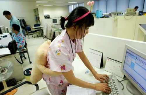 Employees of an underwear company work in pyjamas at their office on February 17, 2006 in Seoul, South Korea. South Korea's underwear company 'Good People Co. Ltd' has a monthly 'Pyjamas Day' during which all employees of the firm work in night attire, so as to get their feedback and inspiration on their products.