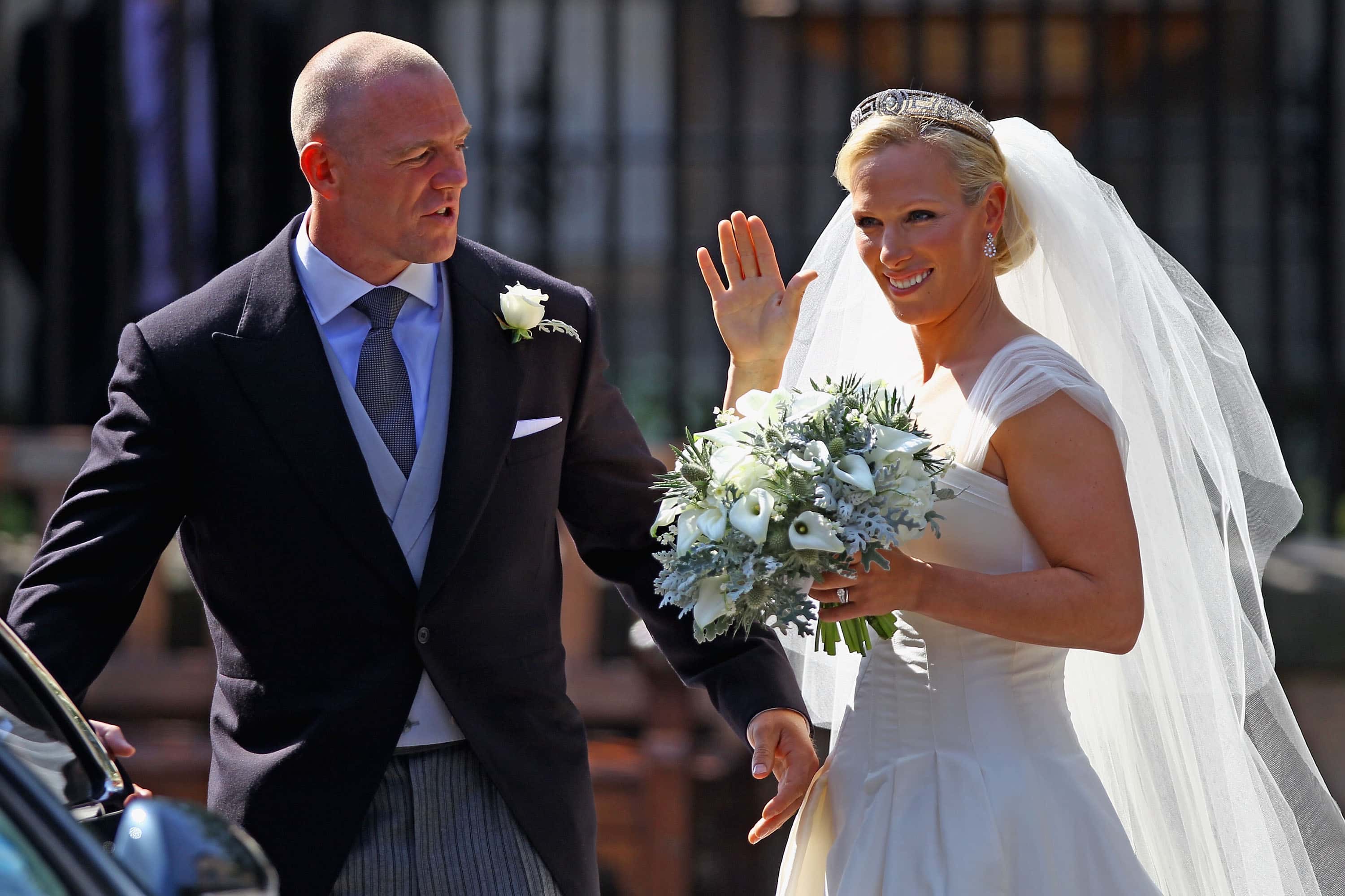 Mike Tindall and Zara Phillips depart after their Royal wedding at Canongate Kirk on July 30, 2011 in Edinburgh, Scotland. The Queen's granddaughter Zara Phillips will marry England rugby player Mike Tindall today at Canongate Kirk. Many royals are expected to attend including the Duke and Duchess of Cambridge. (Photo by Jeff J Mitchell/Getty Images)