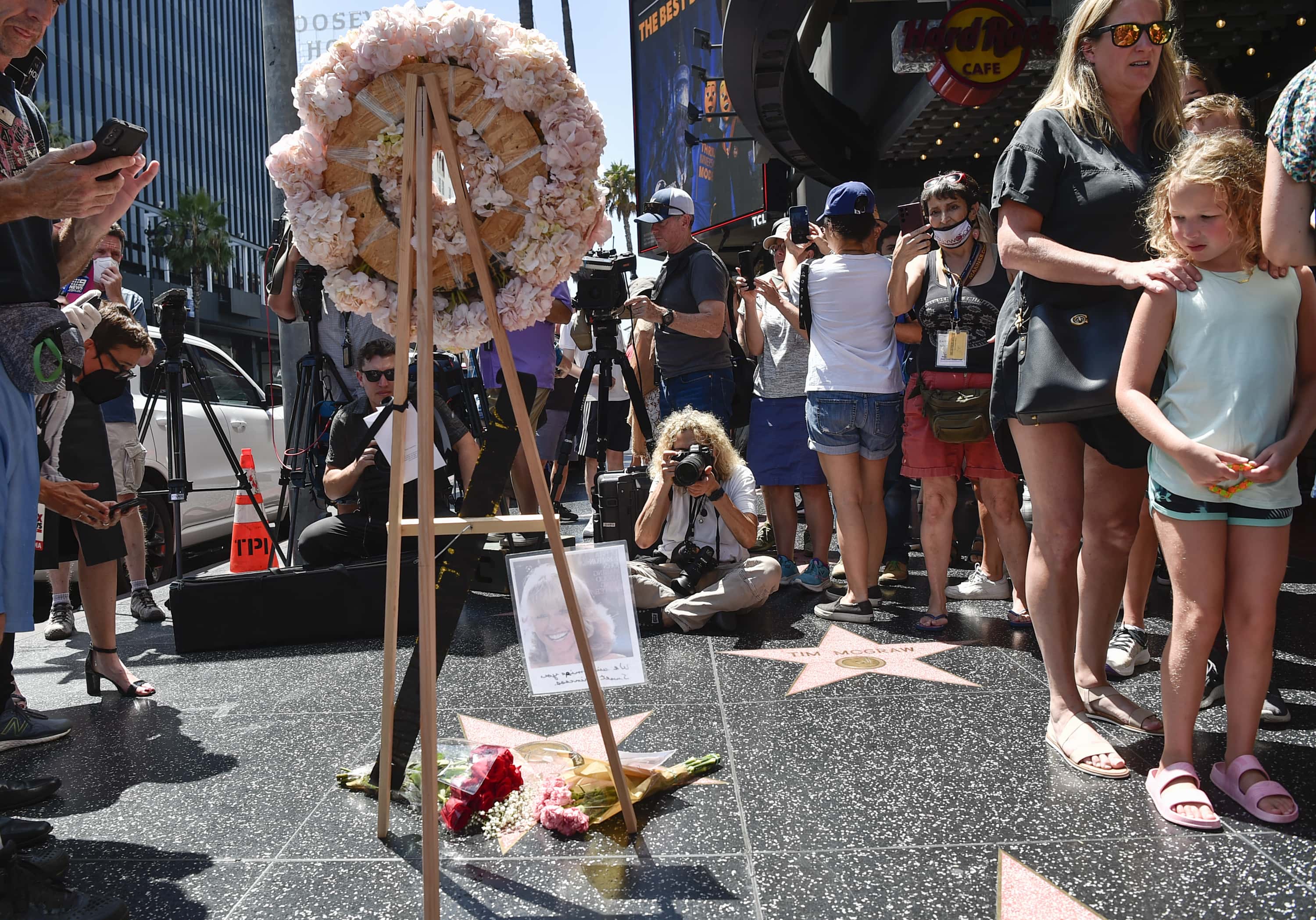 People take pictures of flowers on Olivia Newton-John's Hollywood Walk of Fame star on August 08, 2022 in Hollywood, California. (Photo by Rodin Eckenroth/Getty Images)