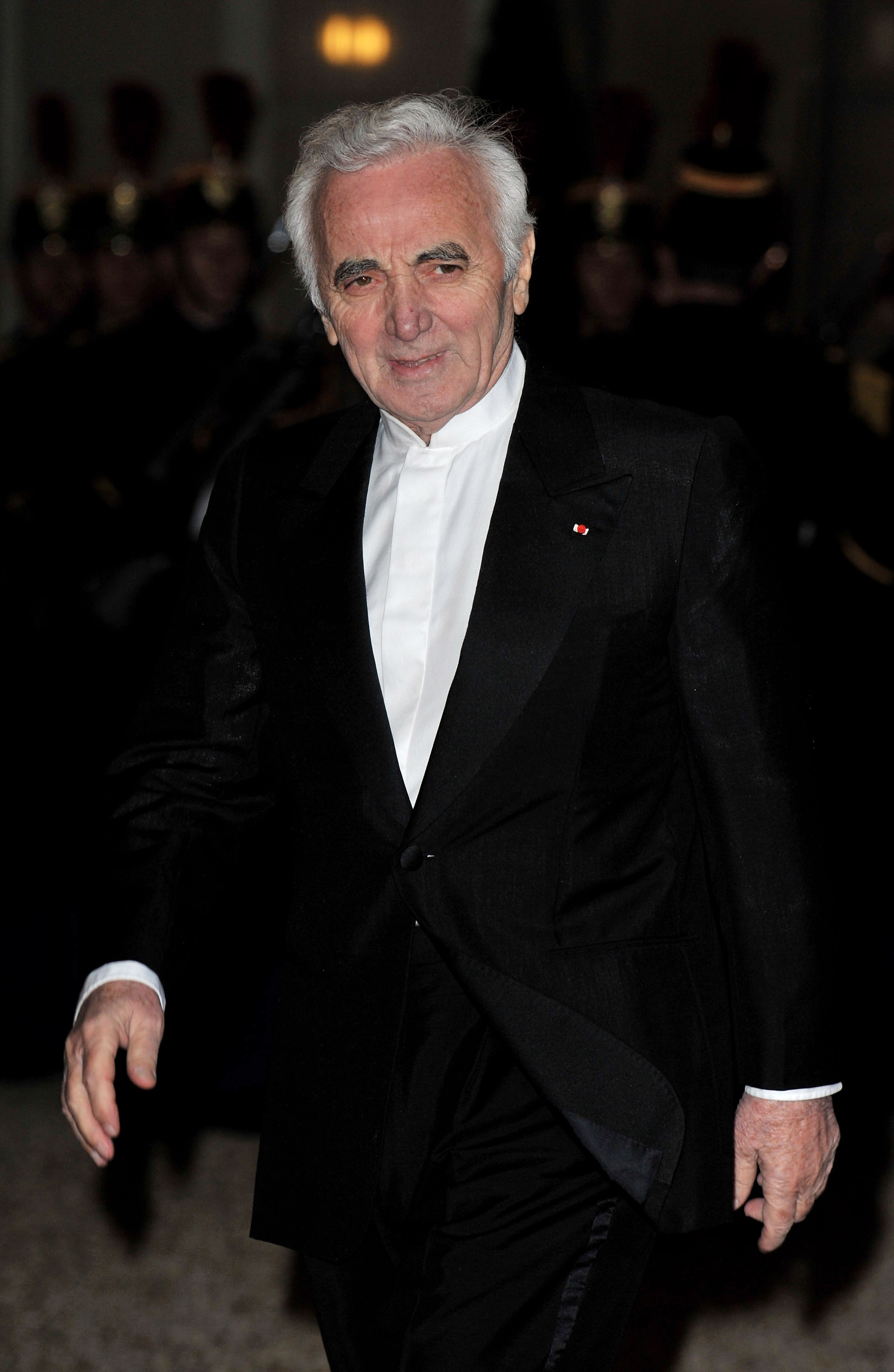 Singer Charles Aznavour arrives to attend a state dinner honouring visiting Russian President Dmitry Medvedev at the Elysee Palace on March 2, 2010 in Paris, France.