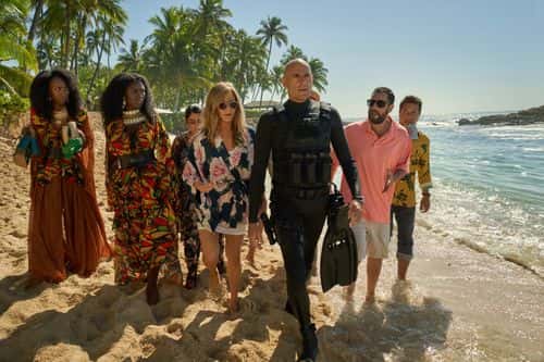 (L-R) Zurin Villanueva, Jodie Turner-Smith, Kuhoo Verma, Jennifer Aniston, Mark Strong, Adam Sandler and Enrique Arce in a still from 'Murder Mystery 2' (Netflix)