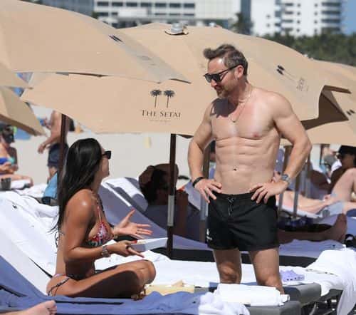 David Guetta displays toned abs while holidaying at Miami beach with girlfriend Jessica Ledon. (Backgrid)