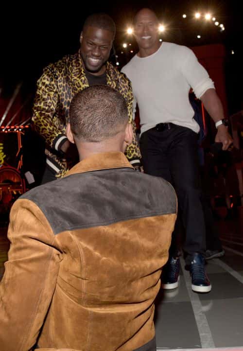 (L-R) Actors Will Smith, Kevin Hart and Dwayne Johnson talk during the 2016 MTV Movie Awards at Warner Bros. Studios on April 9, 2016 in Burbank, California.  MTV Movie Awards airs April 10, 2016 at 8pm ET/PT.