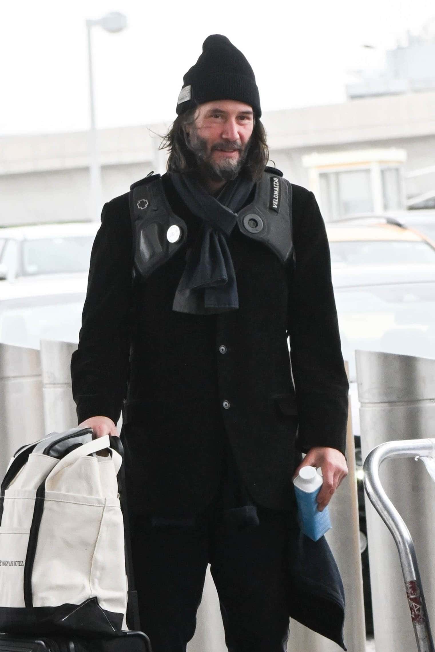 The John Wick star donned a black jacket and pants and covered his dark hair with a black toque (Backgrid)
