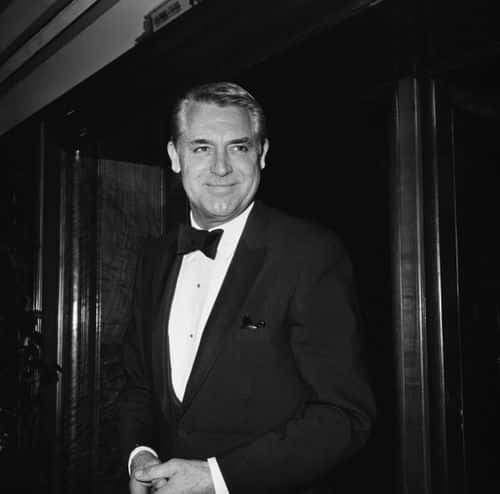 British-born American actor Cary Grant (1904-1986) wearing a tuxedo and bow tie, attends an event, United Kingdom, June 1962. (Photo by Evening Standard/Hulton Archive/Getty Images)