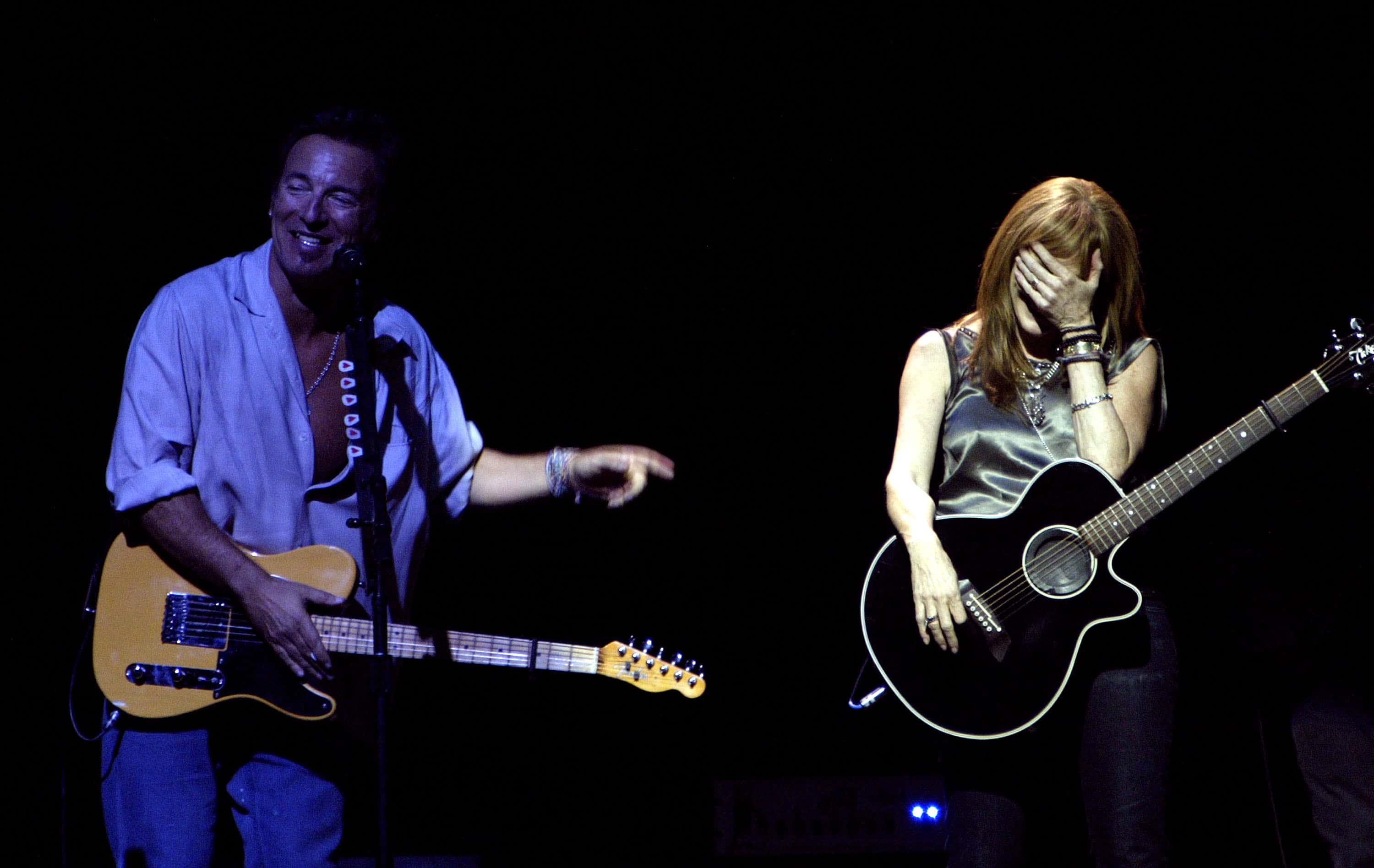 NEW YORK - OCTOBER 13: Patti Scialfa is joined on stage by her husband Bruce Springsteen during the Vote For Change concert at the Continental Airlines Arena October 13, 2004 in East Rutherford, New Jersey. (Photo by Paul Hawthorne/Getty Images)
