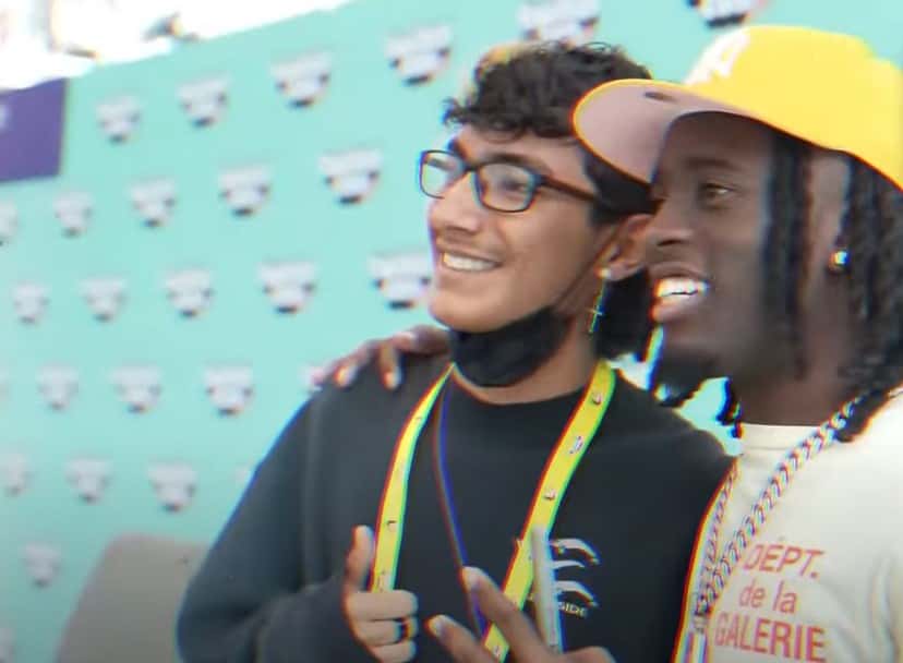 Kai Cenat with his fan at an event (GQ/YouTube)