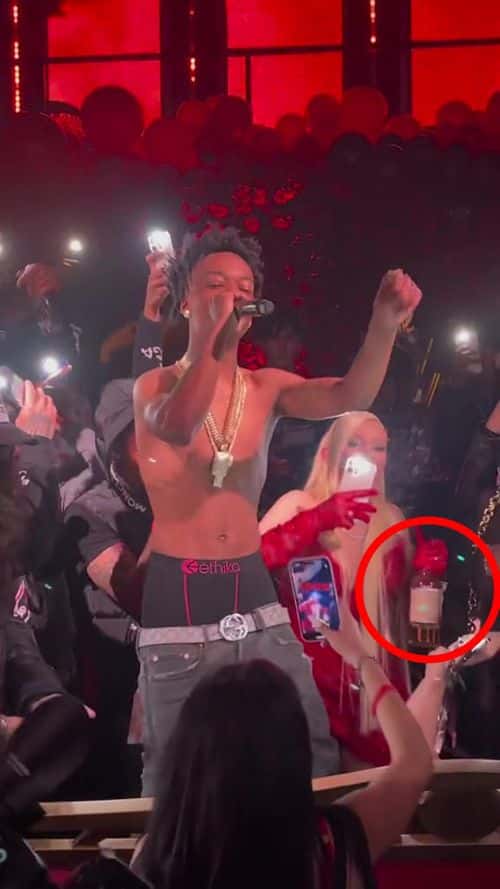 Alabama Barker pictured holding a bottle of alcohol. (@versace_shawty/TikTok)